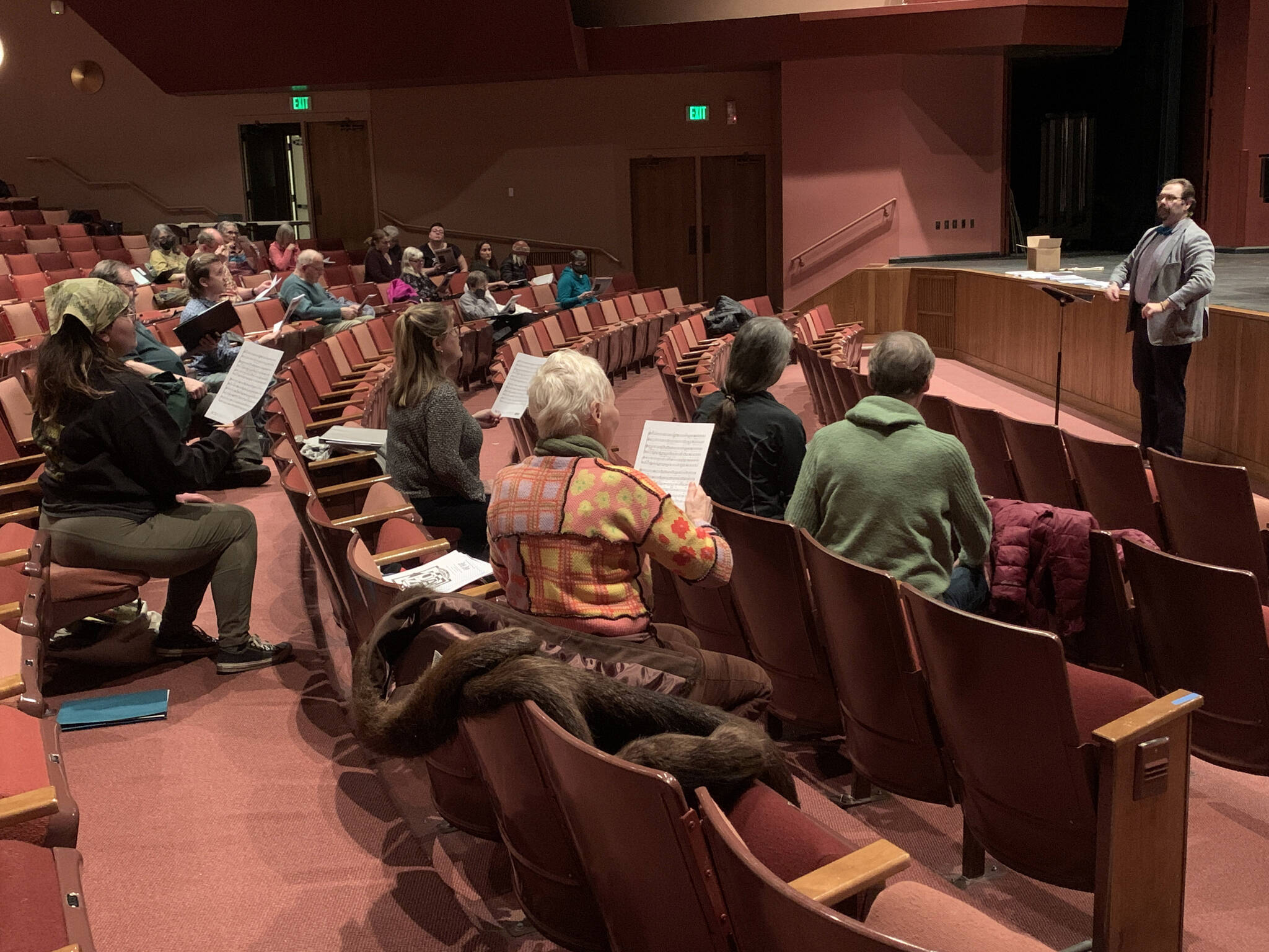 Photo by Christina Whiting/Homer News
Kyle Schneider instructs community members during Feb. 21 community chorus at the Mariner Theatre.