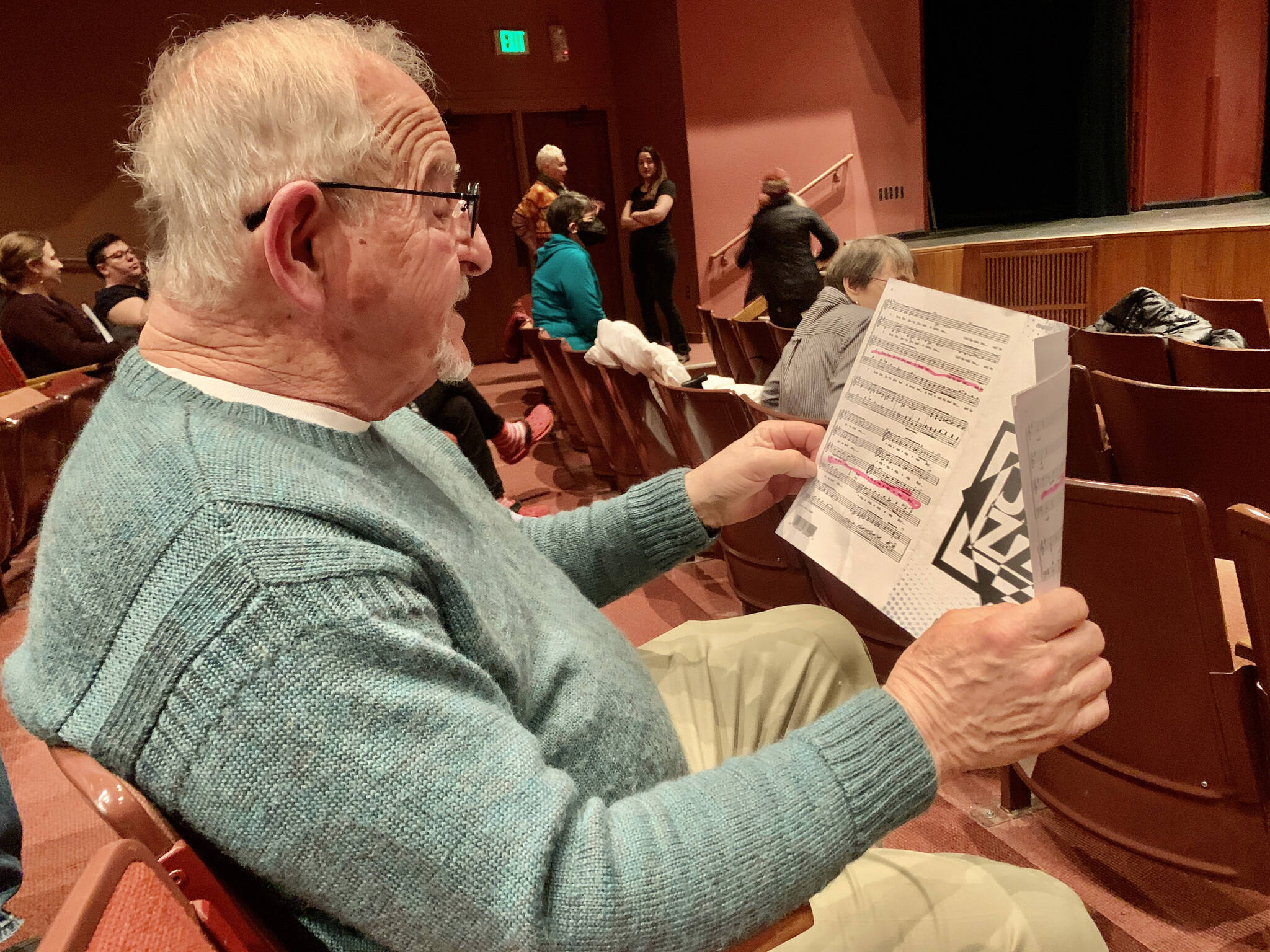 Photo by Christina Whiting/Homer News
Community member Roy Wilson reads music during Feb. 21 community chorus at the Mariner Theatre.