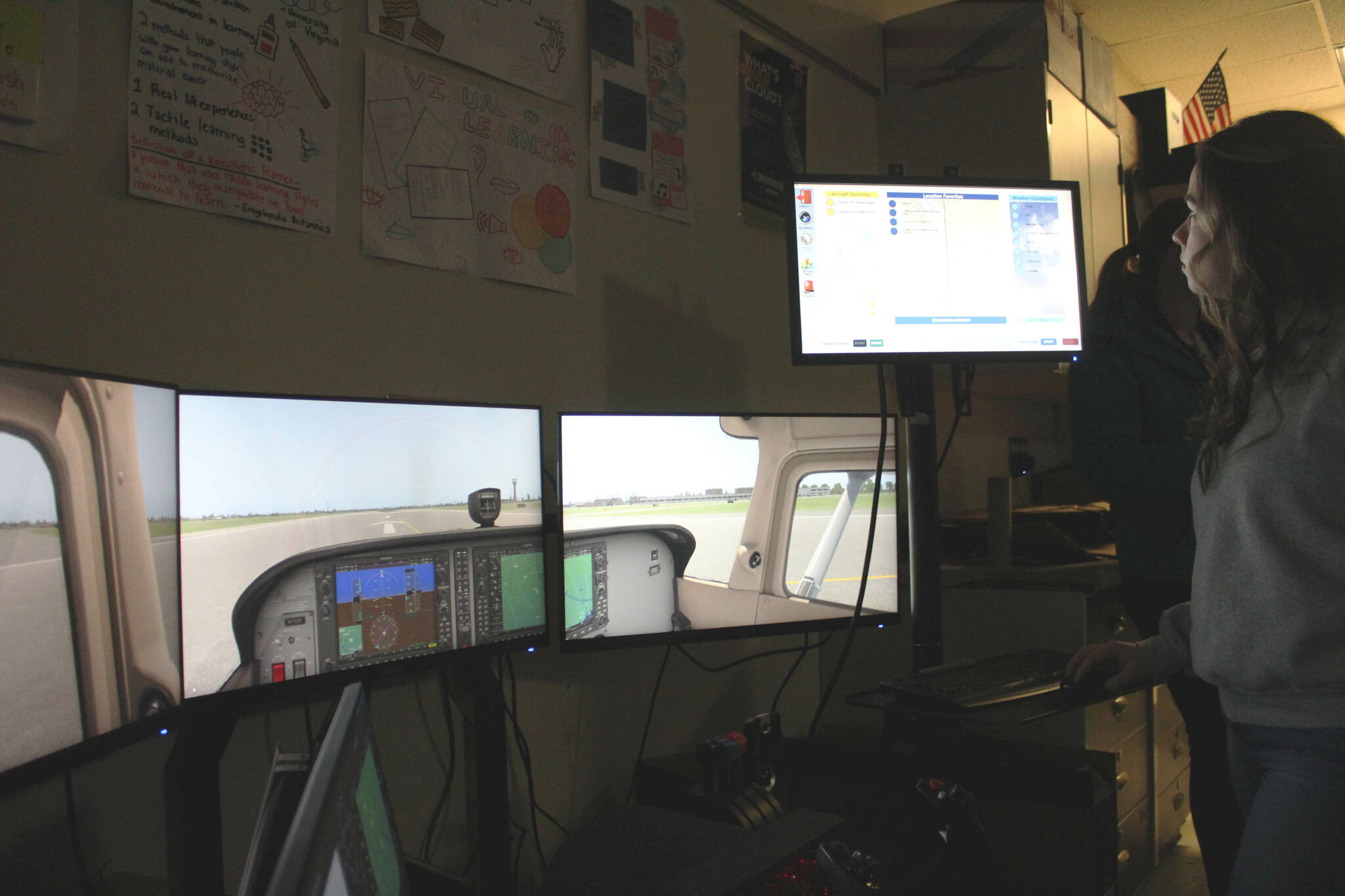 Soldotna High School teacher Jayda Williams operates a flight simulator inside a classroom on Wednesday, Feb. 22, 2023 in Soldotna, Alaska. (Ashlyn O’Hara/Peninsula Clarion)