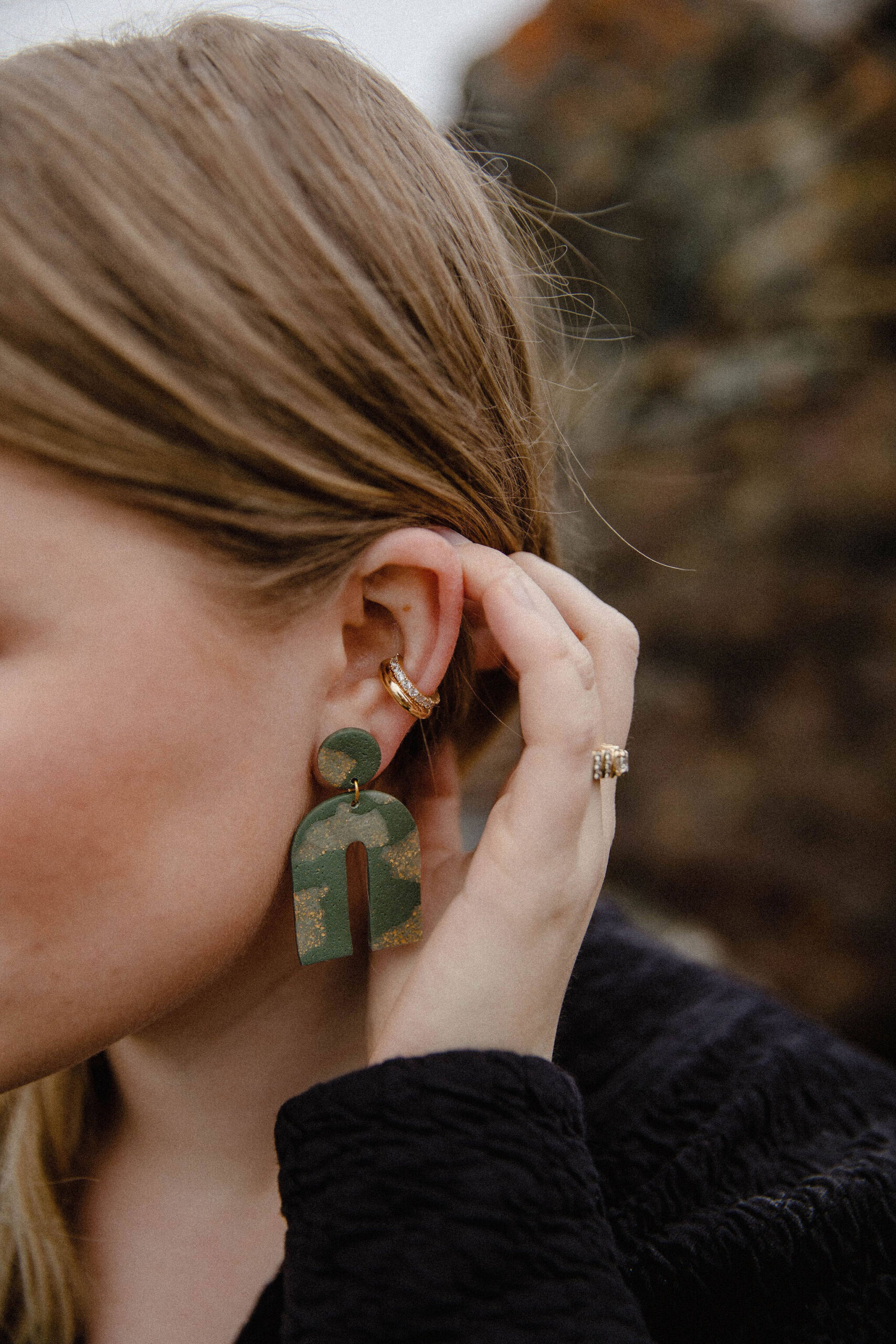 Alyssa Morgan on the Homer Spit modeling a pair of her polymer clay earrings, March 2021. (Photo by Mackenzie Walker of Photos By Kenz)