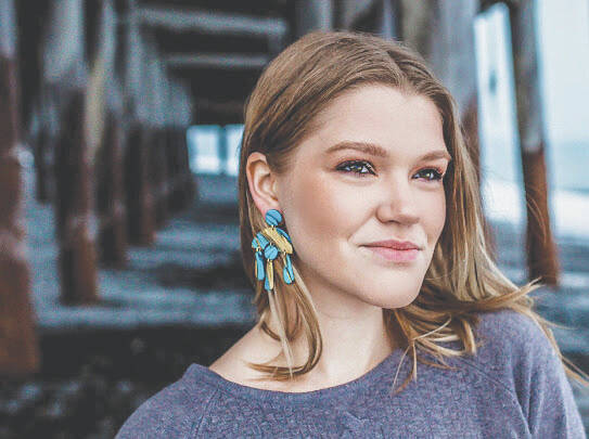 Alyssa Morgan models a pair of her clay earrings. (Photo provided by Alyssa Morgan)