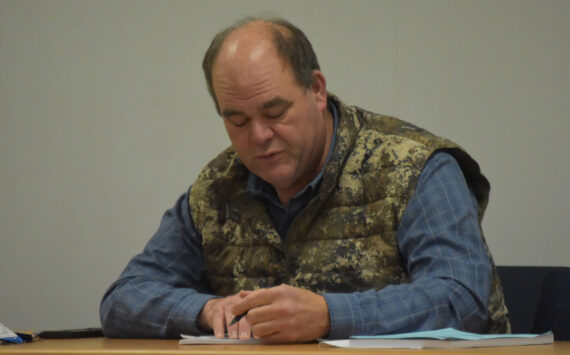 Mike Crawford, Chair of the Kenai/Soldotna Fish and Game Advisory Committee, writes the language of an amendment to Board of Game Proposal 105, passed unanimously by the committee during a meeting on Monday, Jan. 23, 2023, at the Cook Inlet Aquaculture Association in Kenai, Alaska. (Jake Dye/Peninsula Clarion)
