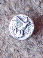 Sterling silver Dove Lotus commemorative pin by Art Koeninger for Celebration of Peace and Reconciliation with American and Vietnamese veterans, 2005, Homer, based on a design by Robert Walsh. (Photo provided by Art copy)