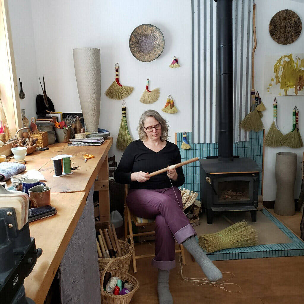 Photo provided by Willow Q Jones
Willow Q Jones making brooms in her home studio, winter 2022.