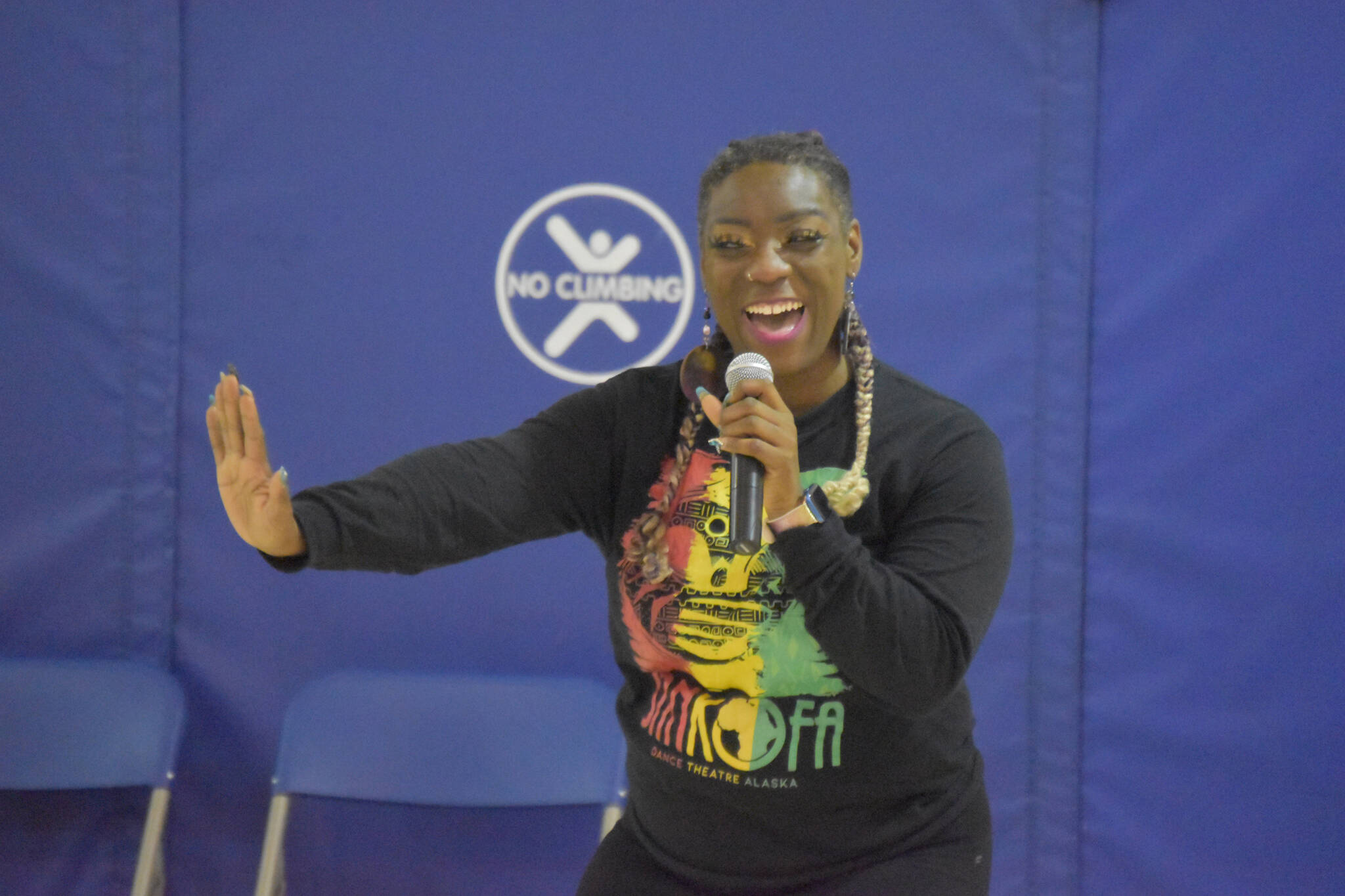 Misha Baskerville sings for a crowd of students during an opening performance by Sankofa Dance Theater Alaska at Kaleidoscope School of Arts and Science in Kenai, Alaska on Monday, March 20, 2023. (Jake Dye/Peninsula Clarion)