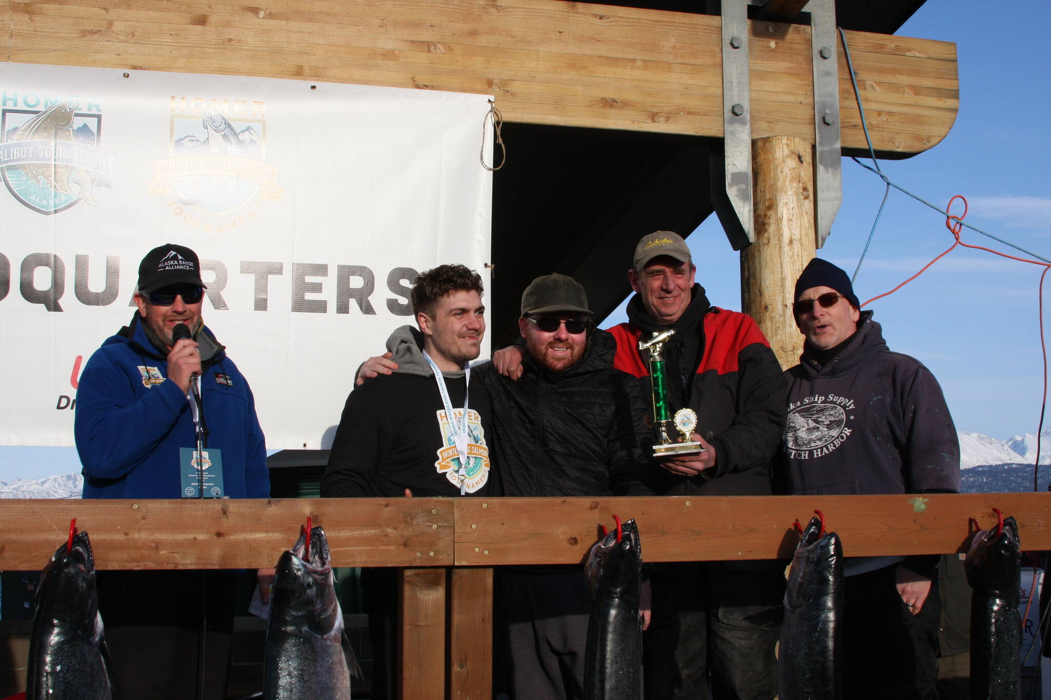 Third place winner Dakota Alward (second from left) poses with his team and trophy during the Homer Winter King Salmon Tournament awards ceremony on Saturday. Photo by Delcenia Cosman