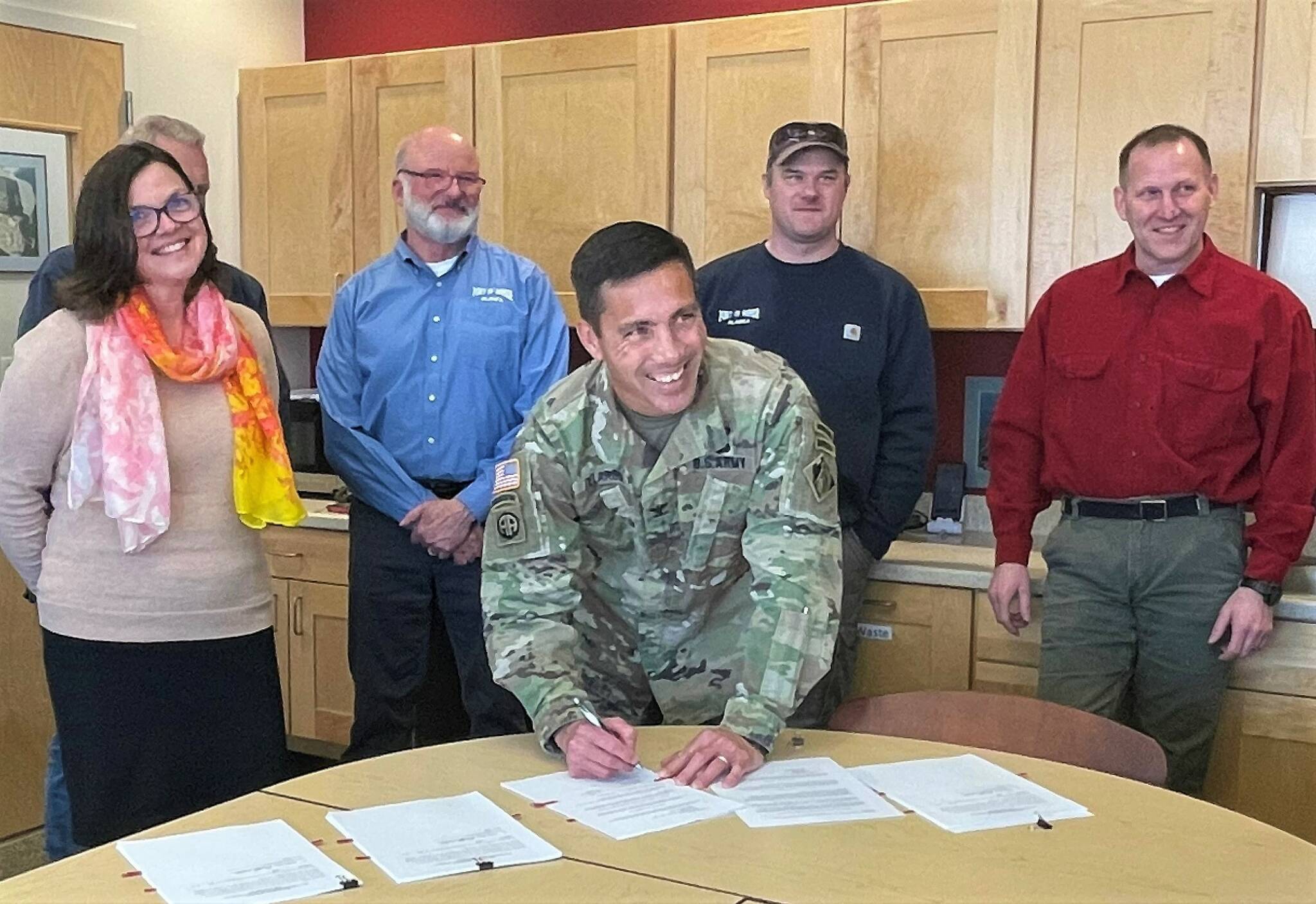 Photo provided by Jenny Carroll
Col. Damon Delarosa, Alaska District Commander USACE (front) signs the feasibility cost-share agreement with the City of Homer on Wednesday, March 29 at the Harbormaster’s Office. Pictured in the back from left to right are Melissa Jacobsen, City Clerk & Acting City Manager; Bryan Hawkins, Harbormaster & Port Director; Aaron Glidden, Port Maintenance Supervisor; and Bruce Sexauer, Chief, Civil Works Project Management at USACE.