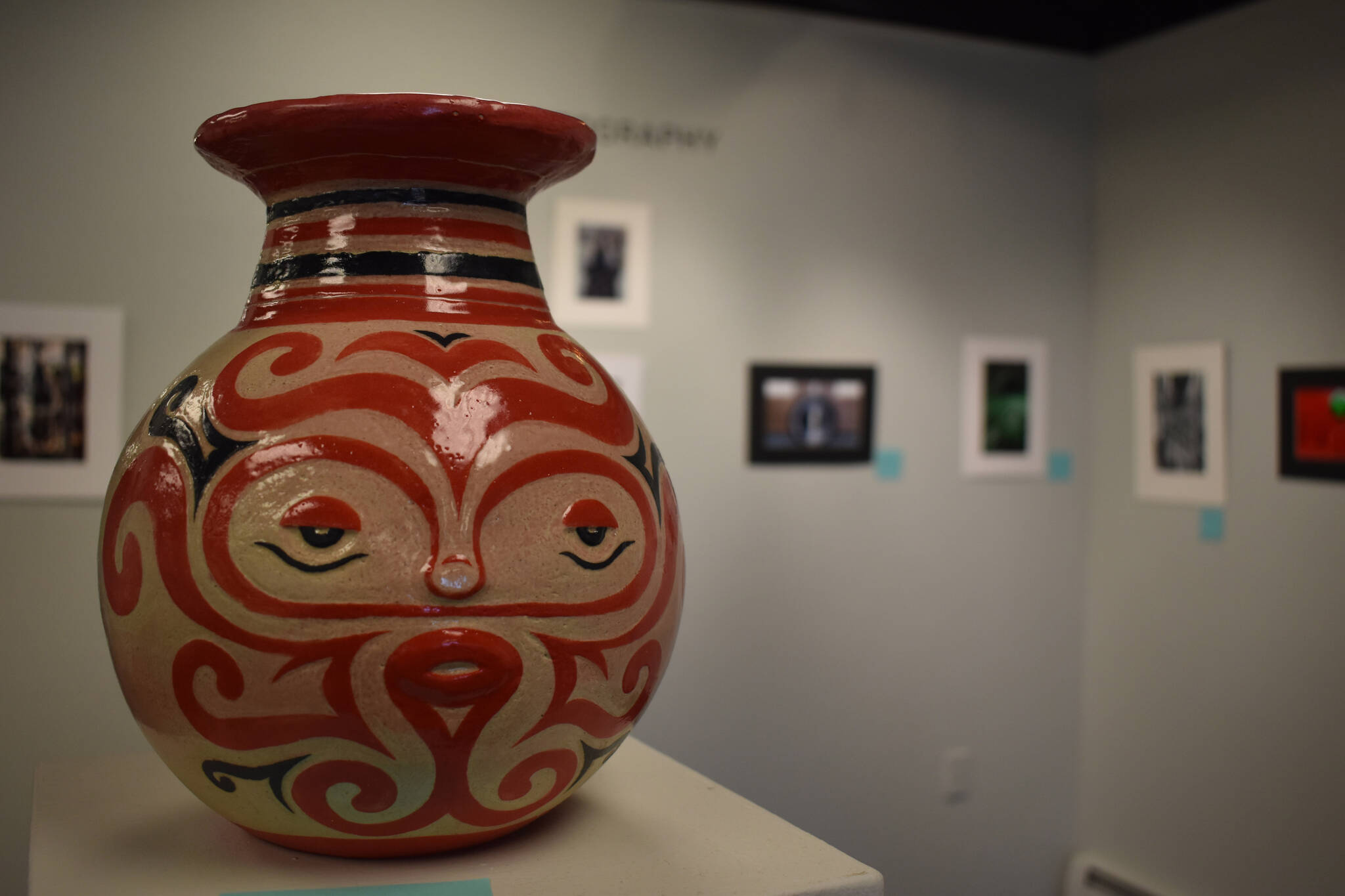 A pot with a detailed face rests on a plinth at the Kenai Art Center in Kenai, Alaska on Wednesday, April 5, 2023, in preparation for the debut of the 32nd Annual Kenai Peninsula Borough School District Visual Feast. (Jake Dye/Peninsula Clarion)