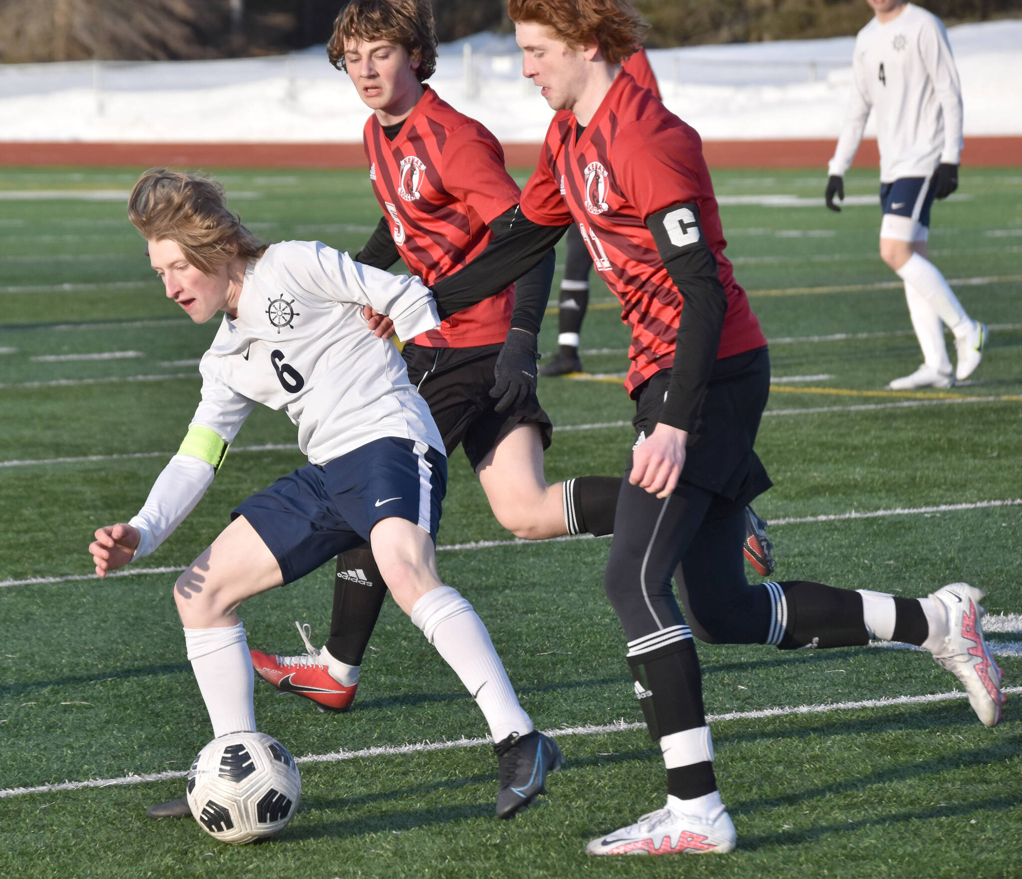 Photo by Jeff Helminiak/Peninsula Clarion
Homer’s Owen Pitzman shields the ball from Kenai Central’s Wade James on April 6 at Ed Hollier Field at Kenai Central High School.