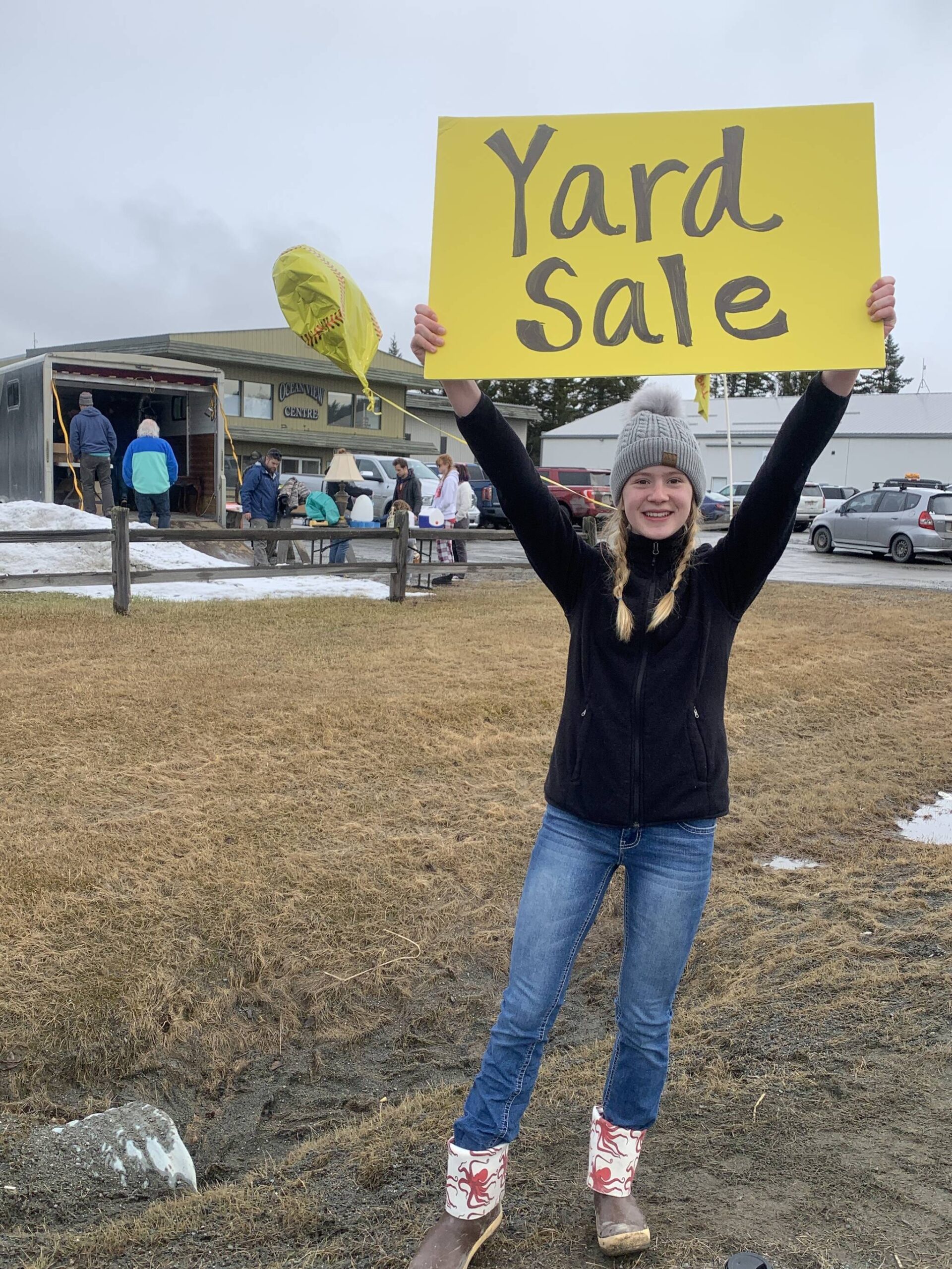 Homer High School freshman Hannah Klima holds a yard sale sign for the fundraiser for HHS Mariner softball on Saturday<ins>, April 15, 2023 in Homer, Alaska</ins>. (Photo by Christina Whiting)