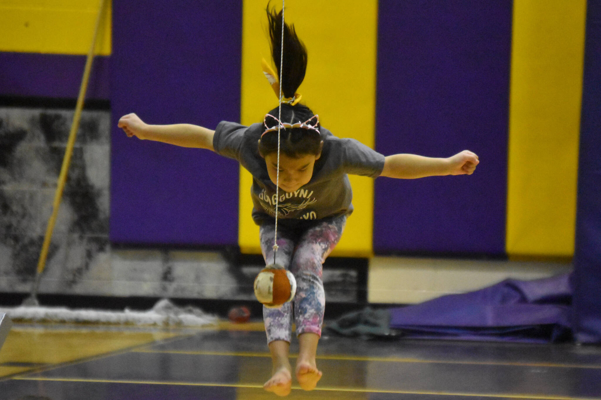 Cameron Ivanoff, competing for the Kenaitze Indian Tribe, performs the 2-Foot High Kick during the Salamatof Tribe Traditional Native Games Invitational at Kenai Middle School in Kenai, Alaska, on Sunday, April 16, 2023. (Jake Dye/Peninsula Clarion)
