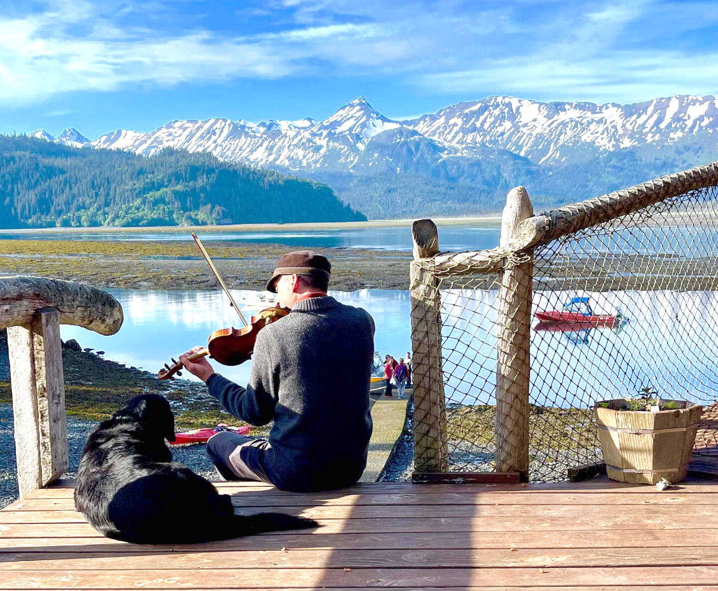 Daniel Perry plays the violin on the steps outside Kachemak Bay Wilderness Lodge in the summer of 2021 in Homer, Alaska. Photo provided by Daniel Perry