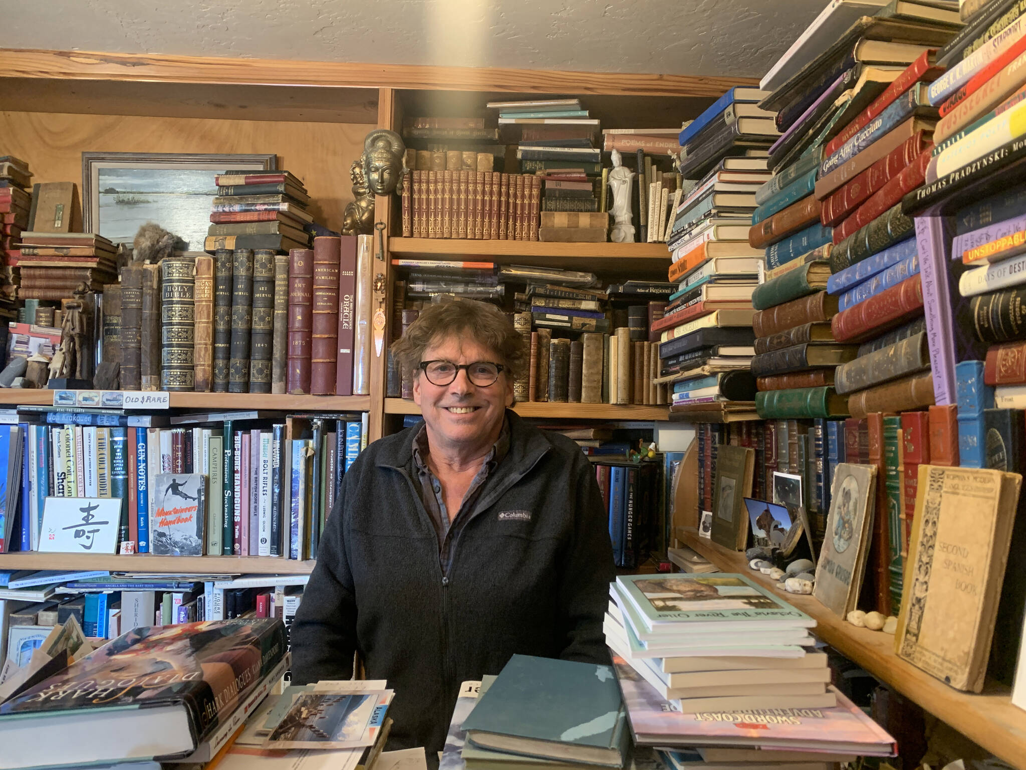 Owner Andy Wills sits behind the front counter of the Old Inlet Bookshop in Old Town Homer<ins>, Alaska</ins> on Tuesday, March 28<ins>, 2023</ins>. Photo by Christina Whiting