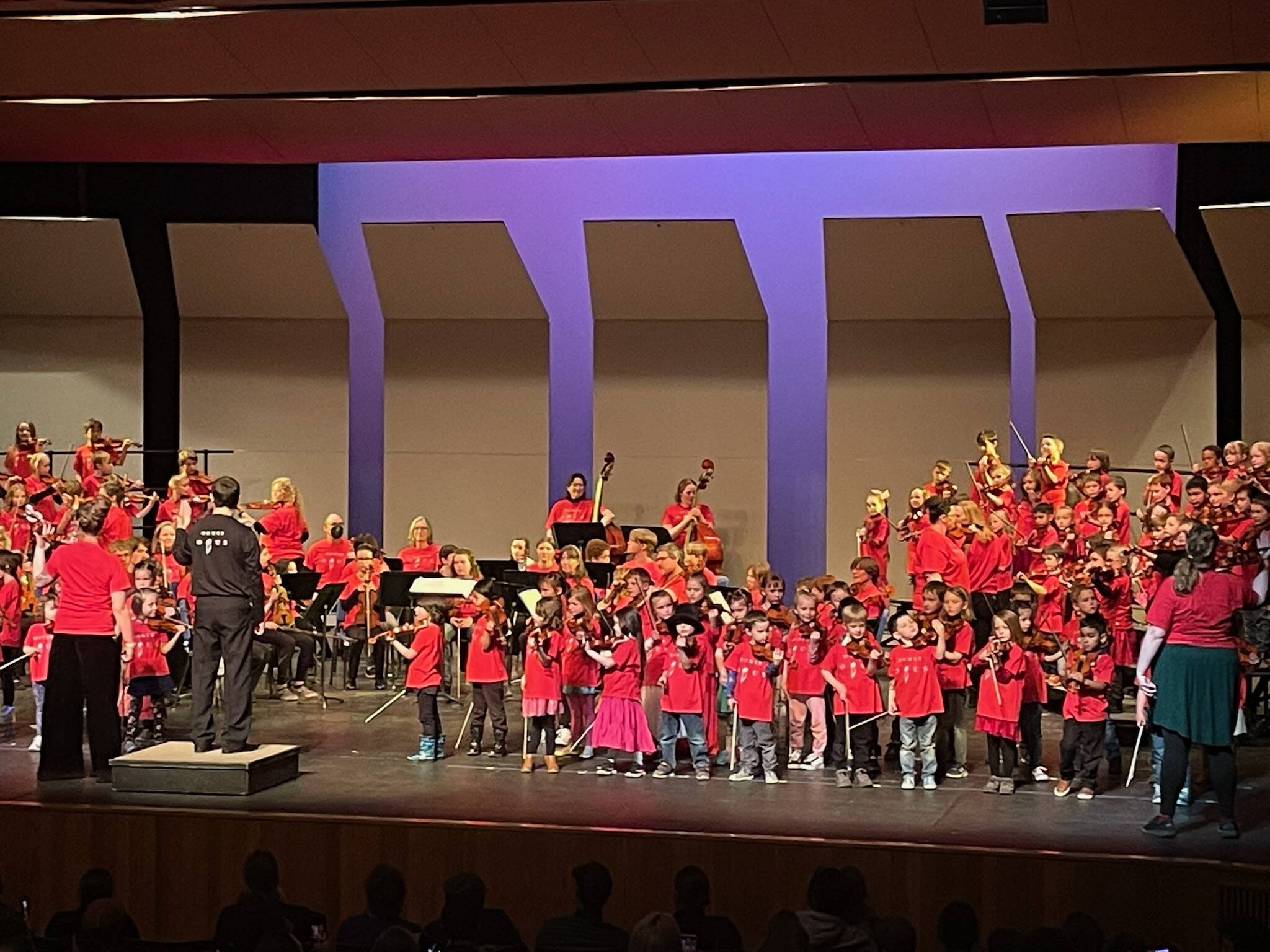 Homer and Anchor Point Kindergarten second grade students perform with members of the Homer Youth String Orchestra Club and adult ensemble Codas at the Mariner Theater on Friday, April 28.  Emilie Springer/Homer News.