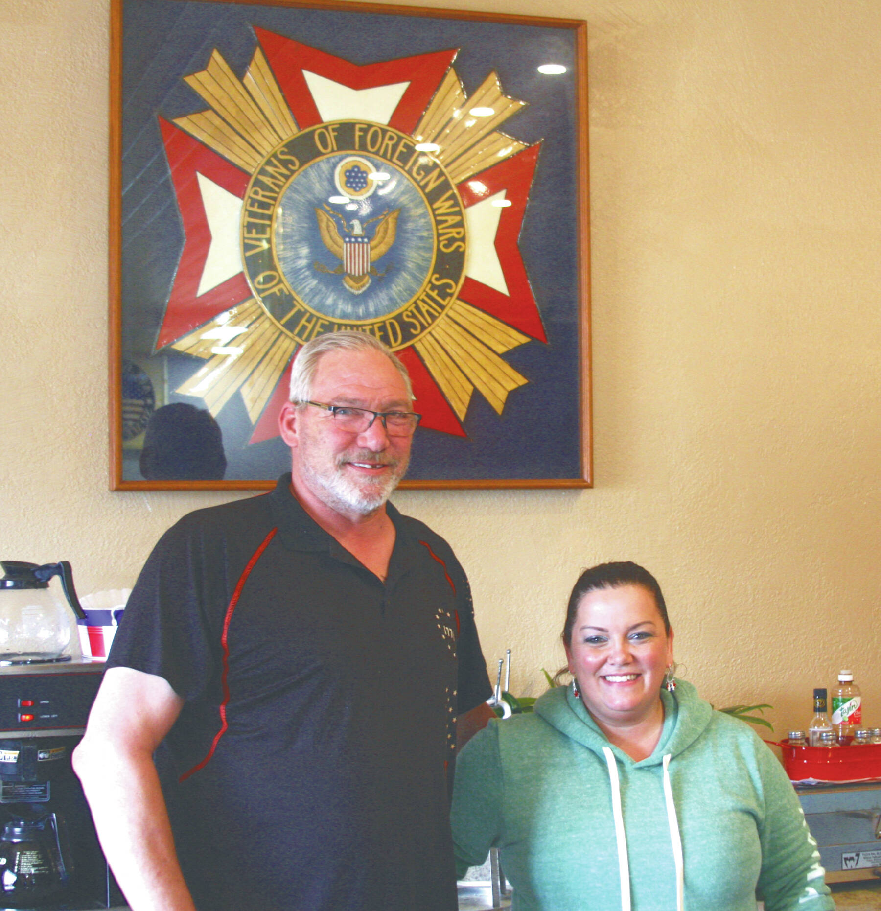 Photo by Delcenia Cosman
VFW Post 10221 commander Chuck Collins and canteen manager Heidi Adams celebrate the post’s grand reopening on Saturday.