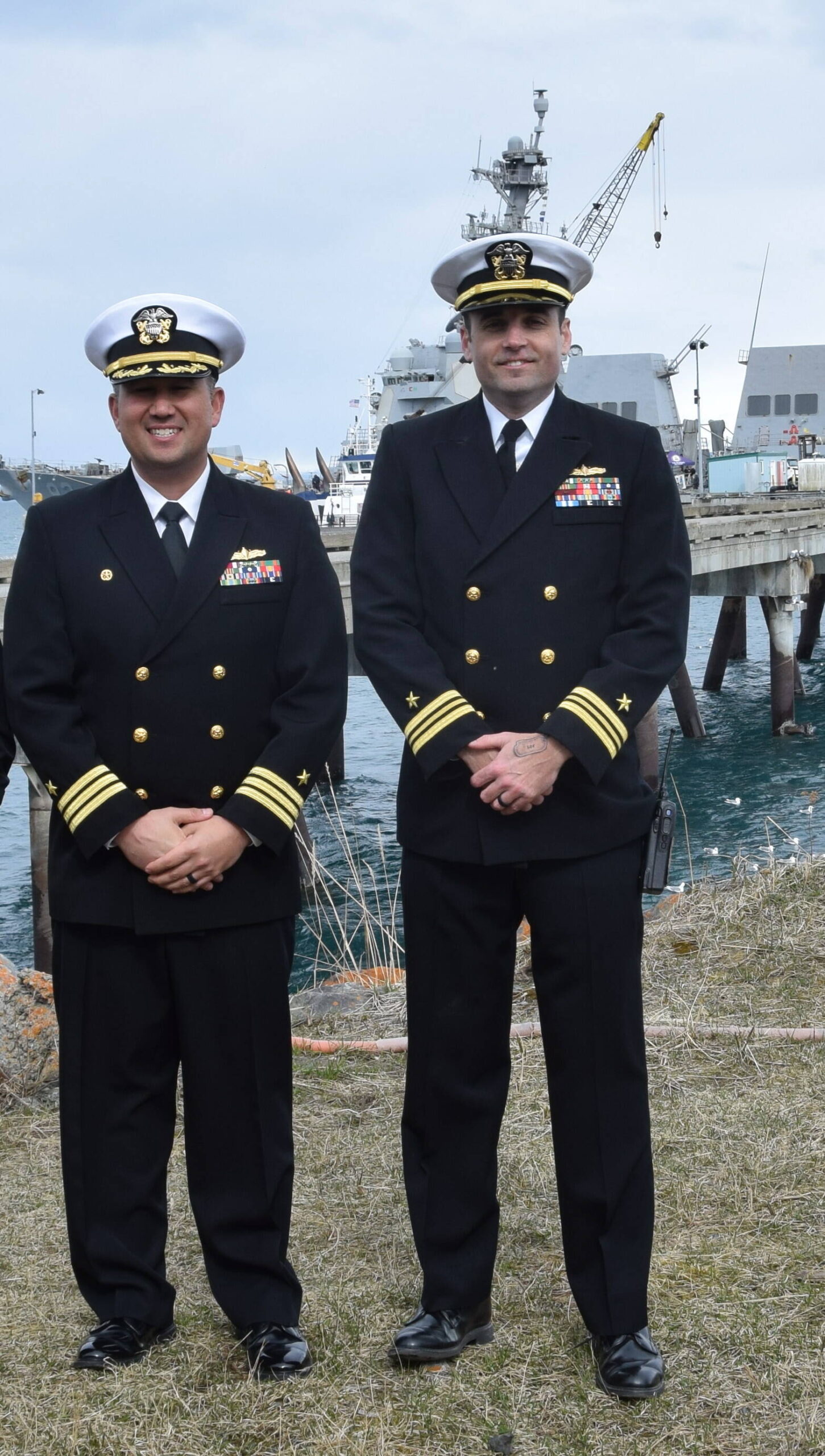 Lt. Cmdr. Russell Allen and Cmdr. Ryan Downing in front of the USS Momsen on May 3, 2023, at Homer's deep water dock. (Emilie Springer/ Homer News)