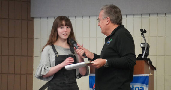 Kiernan Lapp, of Soldotna High School, is introduced by Merrill Sikorski at the Caring for the Kenai Awards Celebration held during a Joint Chamber Luncheon on Wednesday, May 3, 2023, at the Soldotna Regional Sports Complex in Soldotna, Alaska. (Jake Dye/Peninsula Clarion)