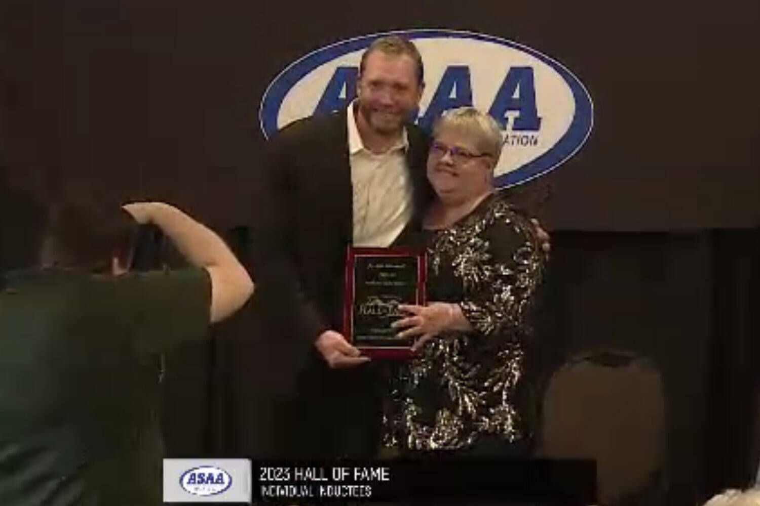 Joshua Gemmell and his mother Carletta Gemmell stand for a photo at the Alaska High School Hall of Fame’s Class of 2023 induction ceremony on Sunday, May 7, 2023, at The Lakefront Hotel in Anchorage, Alaska. (Screenshot)