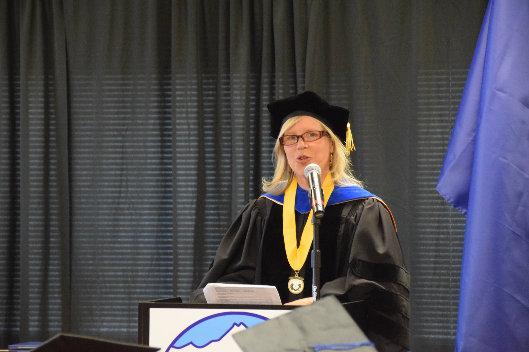 Kachemak Bay Campus Professor of Biology and Semester by the Bay coordinator Dr. Debbie Tobin presents the University of Alaska certificates and diplomas to graduates during the 2023 KBC Commencement on Wednesday, May 10, 2023, in Homer, Alaska. (Photo by Delcenia Cosman/Homer News)