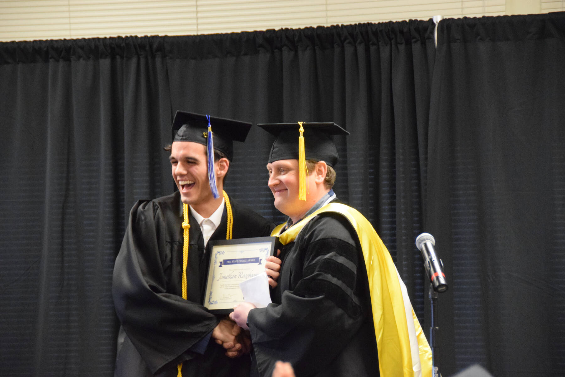 Kachemak Bay Campus Assistant Professor of History Dr. Jeff Meyers (right) presents the KBC Staff Choice award to Jonathan Rozeboom (left) during the 2023 KBC Commencement on Wednesday, May 10, 2023, in Homer, Alaska. (Photo by Delcenia Cosman/Homer News)