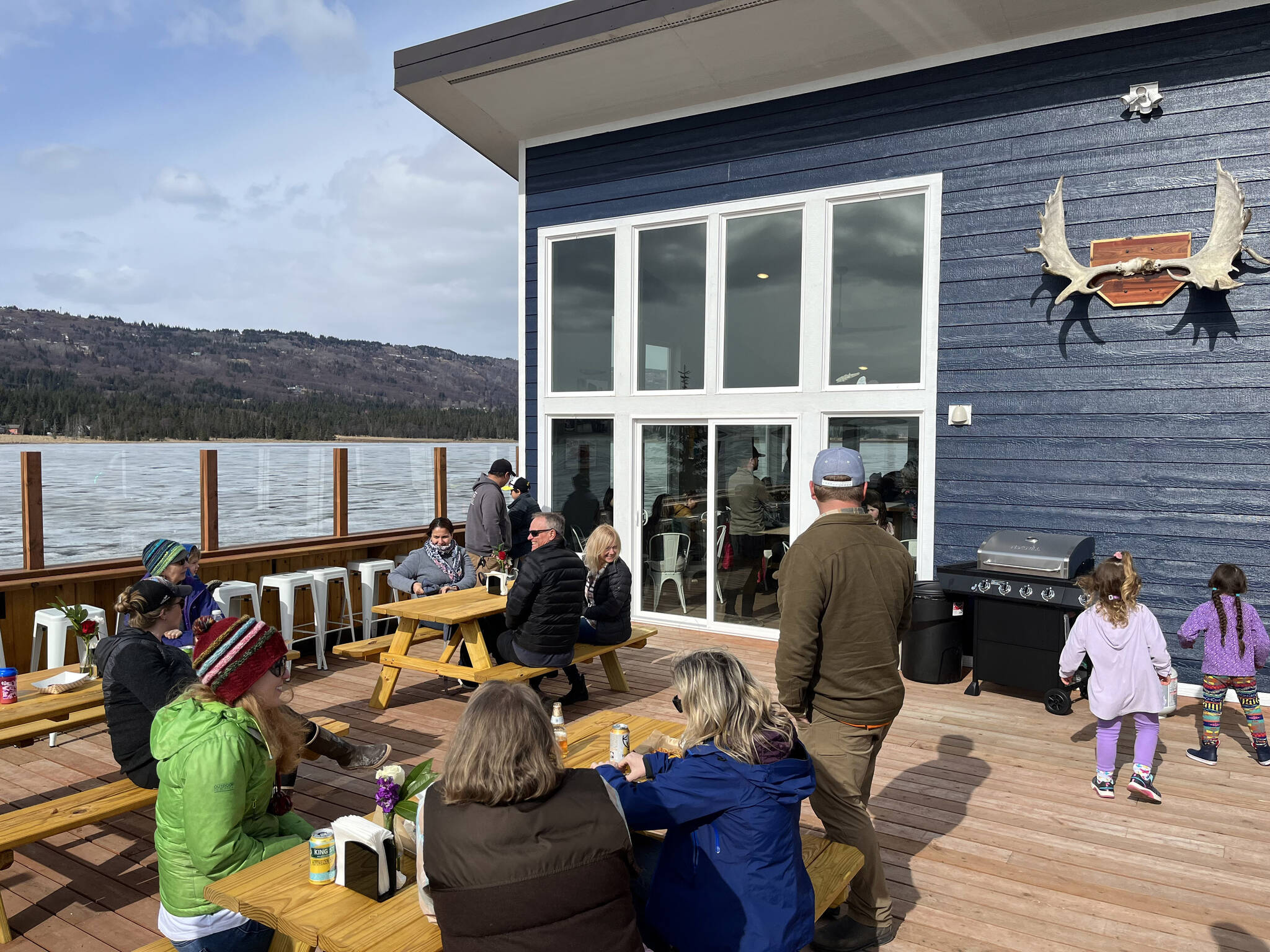 Community members enjoy the deck on opening day of The Tickled Pear restaurant, formerly a food truck, May 5, 2023. (Photo provided by Stephanie Greer)