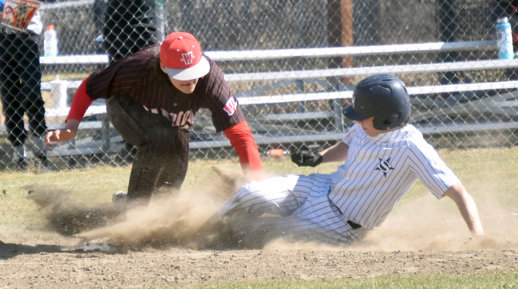 Wasilla third baseman Logan Bean tags out Soldotna’s Levi Mickelson on Saturday, May 13, 2023, at the Soldotna Little League fields in Soldotna, Alaska. (Photo by Jeff Helminiak/Peninsula Clarion)