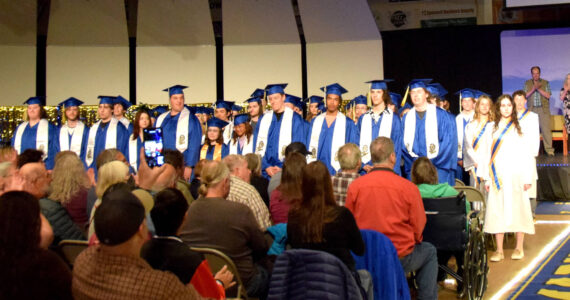 Homer High School 2023 graduating seniors stand during commencement in the Homer High School’s Alice Witte Gymnasium, May 15, 2023, in Homer, Alaska. (Photo by Emilie Springer/ Homer News)