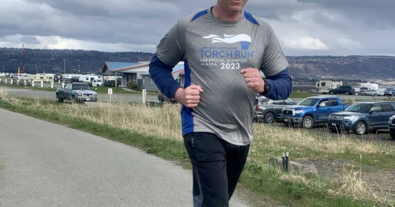 Sergeant Dave Shealy runs along the Homer Spit bike path, participating in the Annual Law Enforcement Torch Run for Special Olympics on Saturday, May 20.