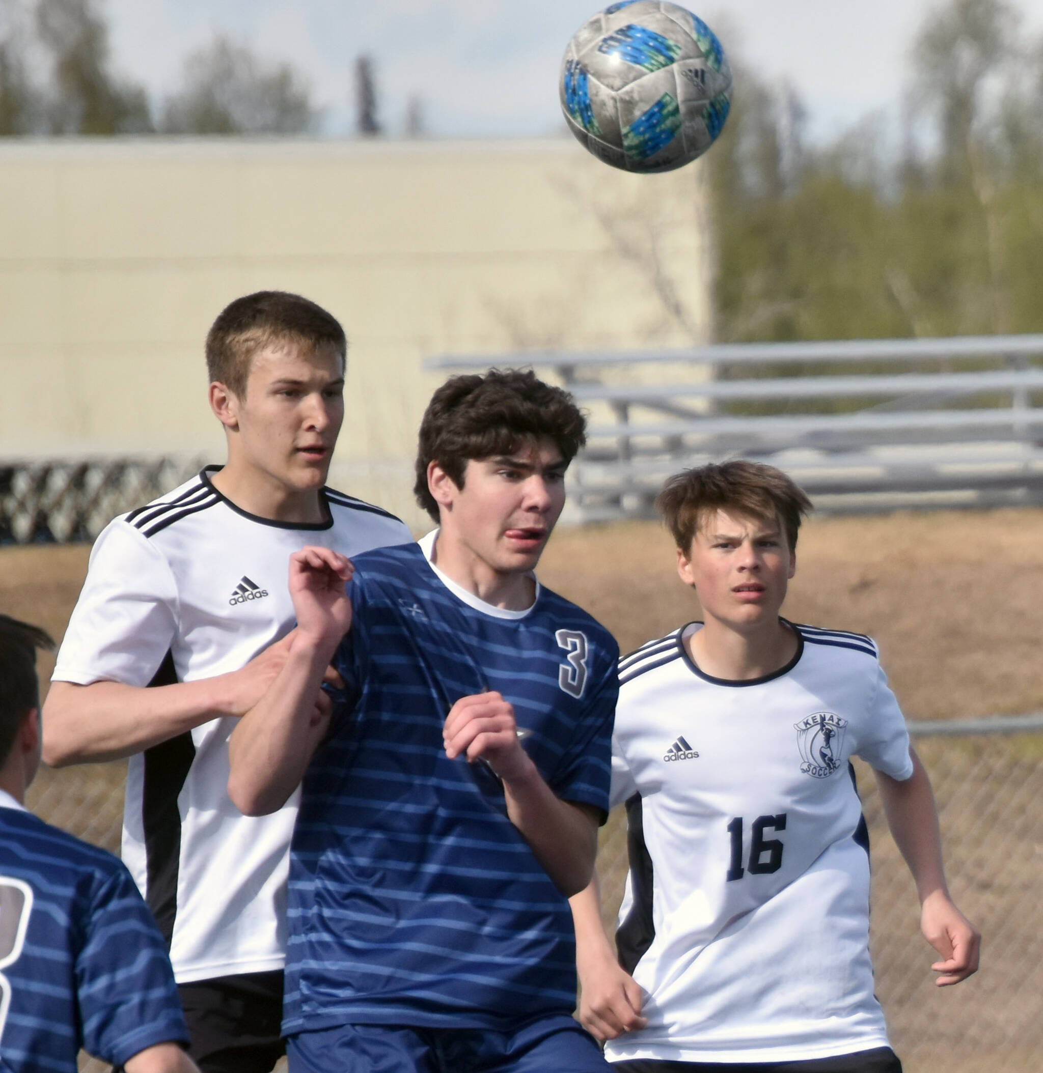 Kenai Central’s Bridger Beck and Sawyer Vann, and Soldotna’s Andrew Arthur battle for the ball Saturday, May 20, 2023, in the championship game of the Peninsula Conference tournament at Justin Maile Field at Soldotna High School in Soldotna, Alaska. (Photo by Jeff Helminiak/Peninsula Clarion)