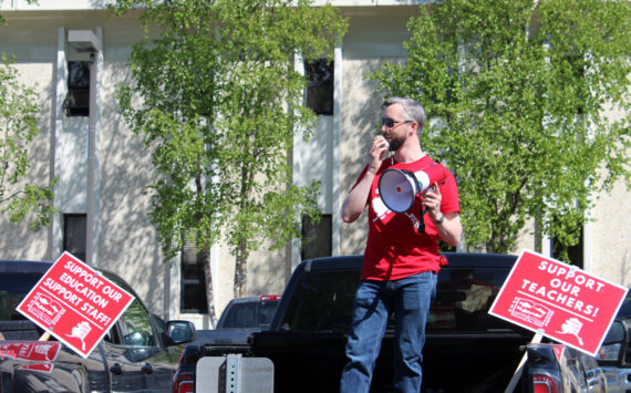 Kenai Peninsula Education Association President Nathan Erfurth speaks from the bed of his truck in support of Kenai Peninsula Borough School District teachers and support staff outside of the George A. Navarre Admin Building on Thursday, May 26, 2022, in Soldotna, Alaska. Erfurth was removed this week as president of the Kenai Peninsula Borough School District’s teachers union, days after he was arrested Saturday on two charges of sexual abuse of a minor. (Ashlyn O’Hara/Peninsula Clarion)