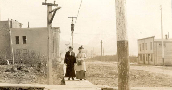 Photo #1.628 courtesy of the Seward Community Library Association
Dr. John Baughman’s wife, Mina (left), poses in this circa 1905-10 photo with Mrs. E.E. Hale on a Seward city sidewalk near the Alaska Central Railroad and Seward’s first school.