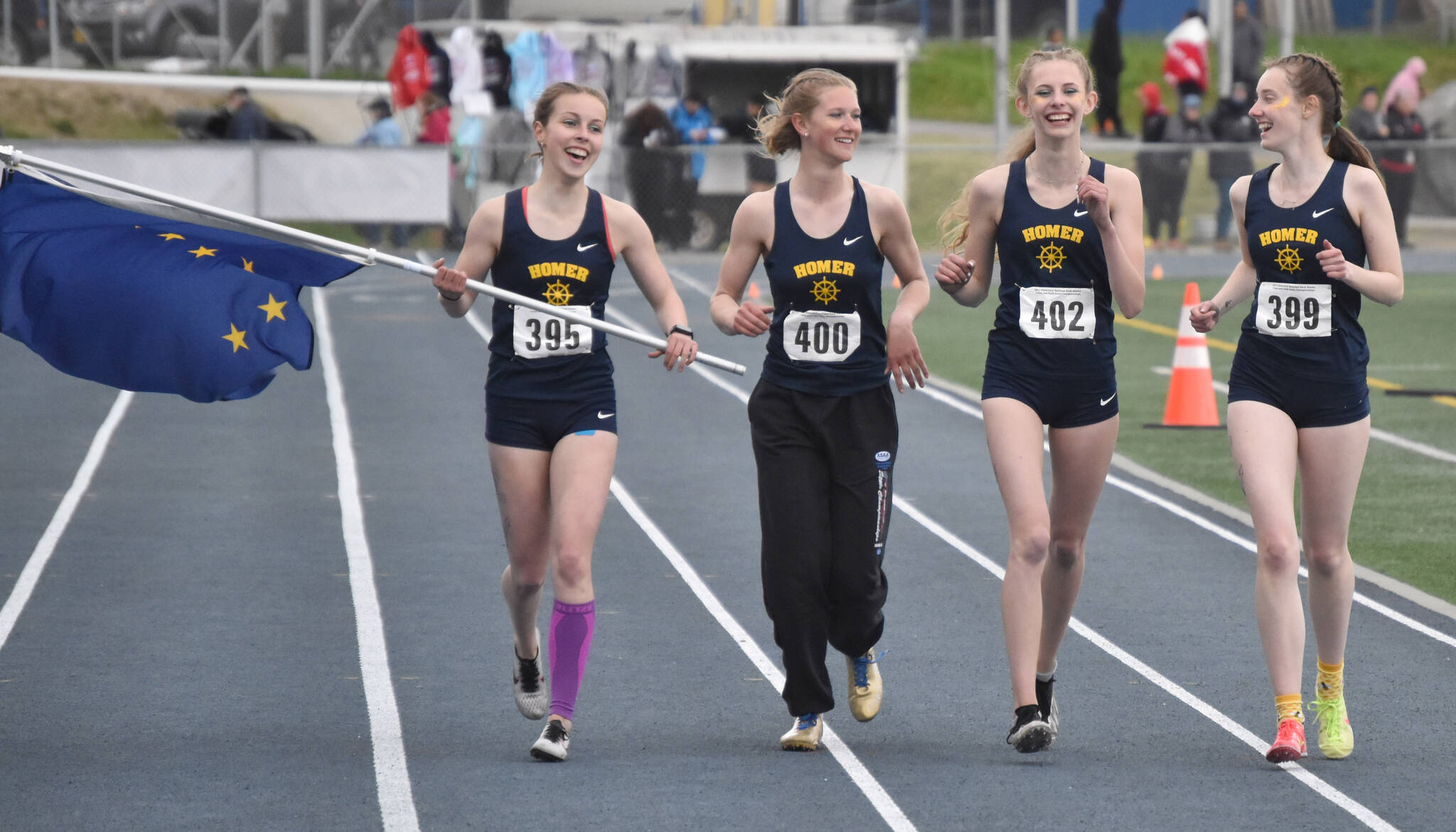 Homer’s Eryn Field, Gracie Miotke, Brightly Thoning and Beatrix McDonough celebrate winning the Division II 1,600-meter relay Saturday, May 27, 2023, at the state track and field meet at Palmer High School in Palmer, Alaska. (Photo by Jeff Helminiak/Peninsula Clarion)