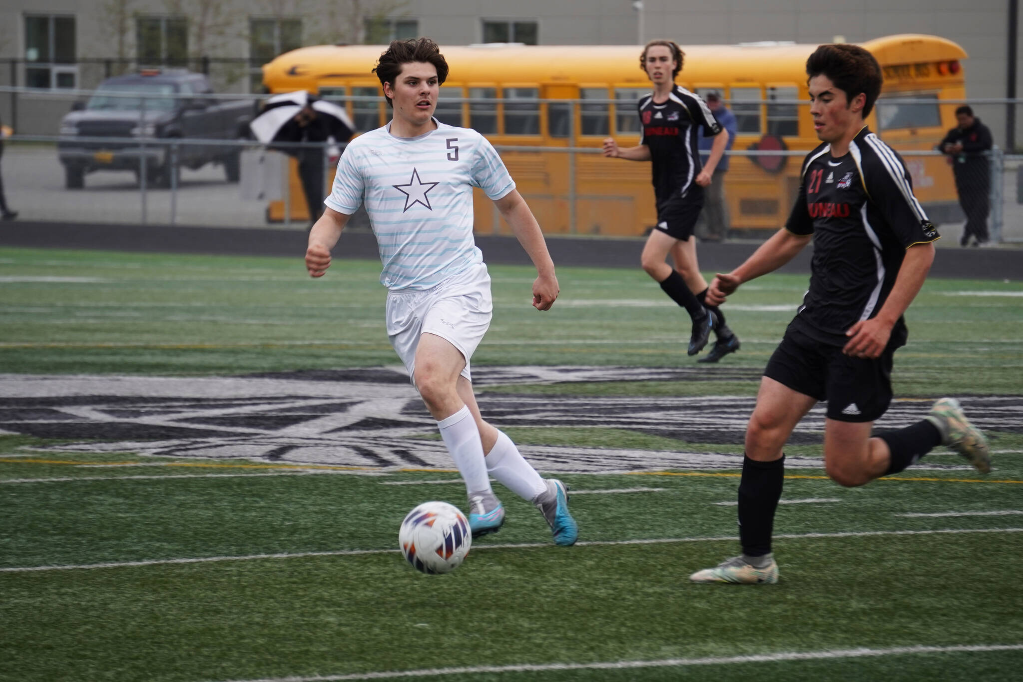 Soldotna’s Gehret Medcoff and Juneau-Douglas’ Gabriel Cheng race for the ball during the Division II Soccer State Championship on Saturday, May 27, 2023, at West Anchorage High School in Anchorage, Alaska. (Jake Dye/Peninsula Clarion)