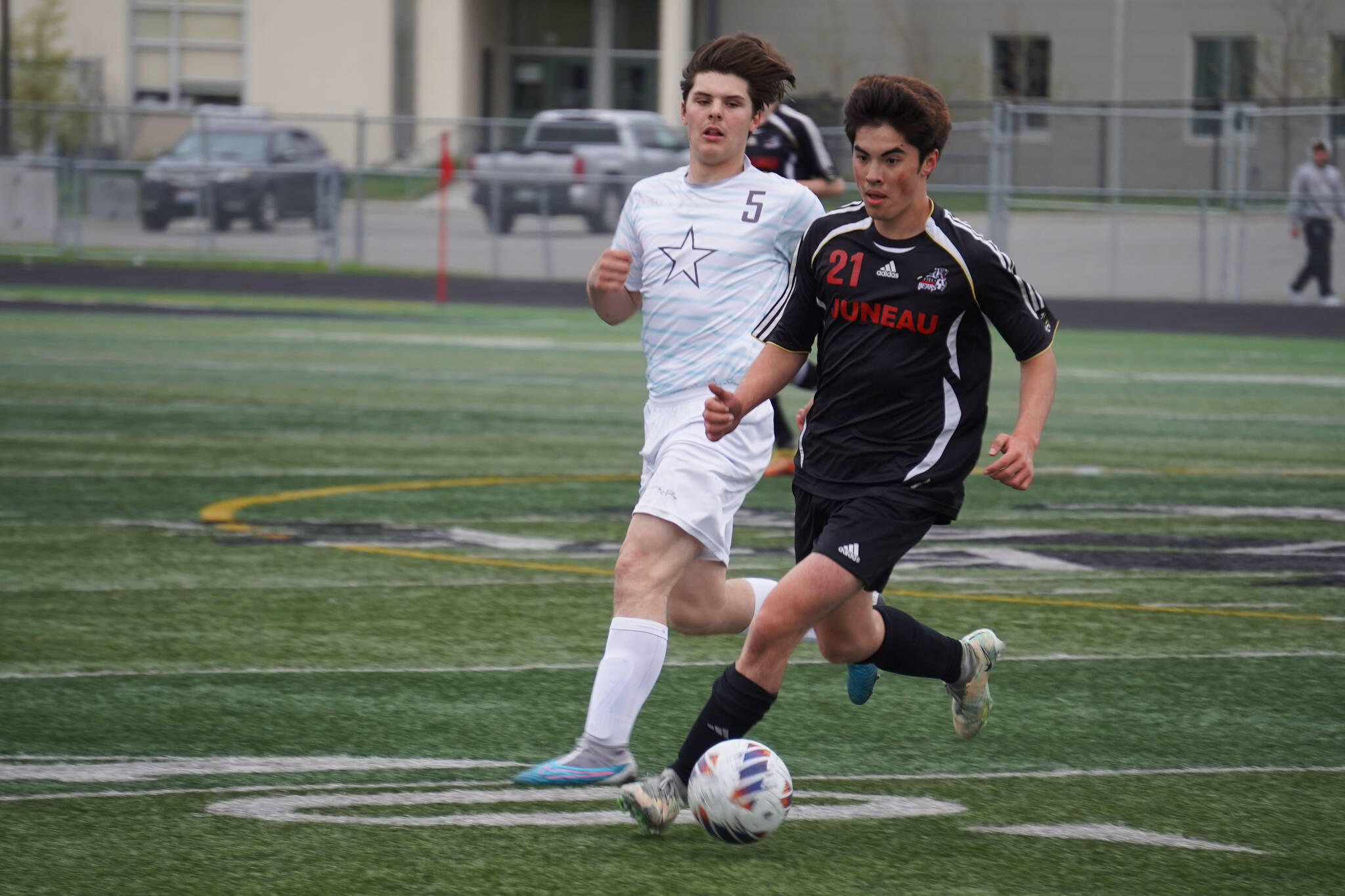 Soldotna’s Gehret Medcoff and Juneau-Douglas’ Gabriel Cheng race for the ball during the Division II Soccer State Championship on Saturday, May 27, 2023, at West Anchorage High School in Anchorage, Alaska. (Jake Dye/Peninsula Clarion)