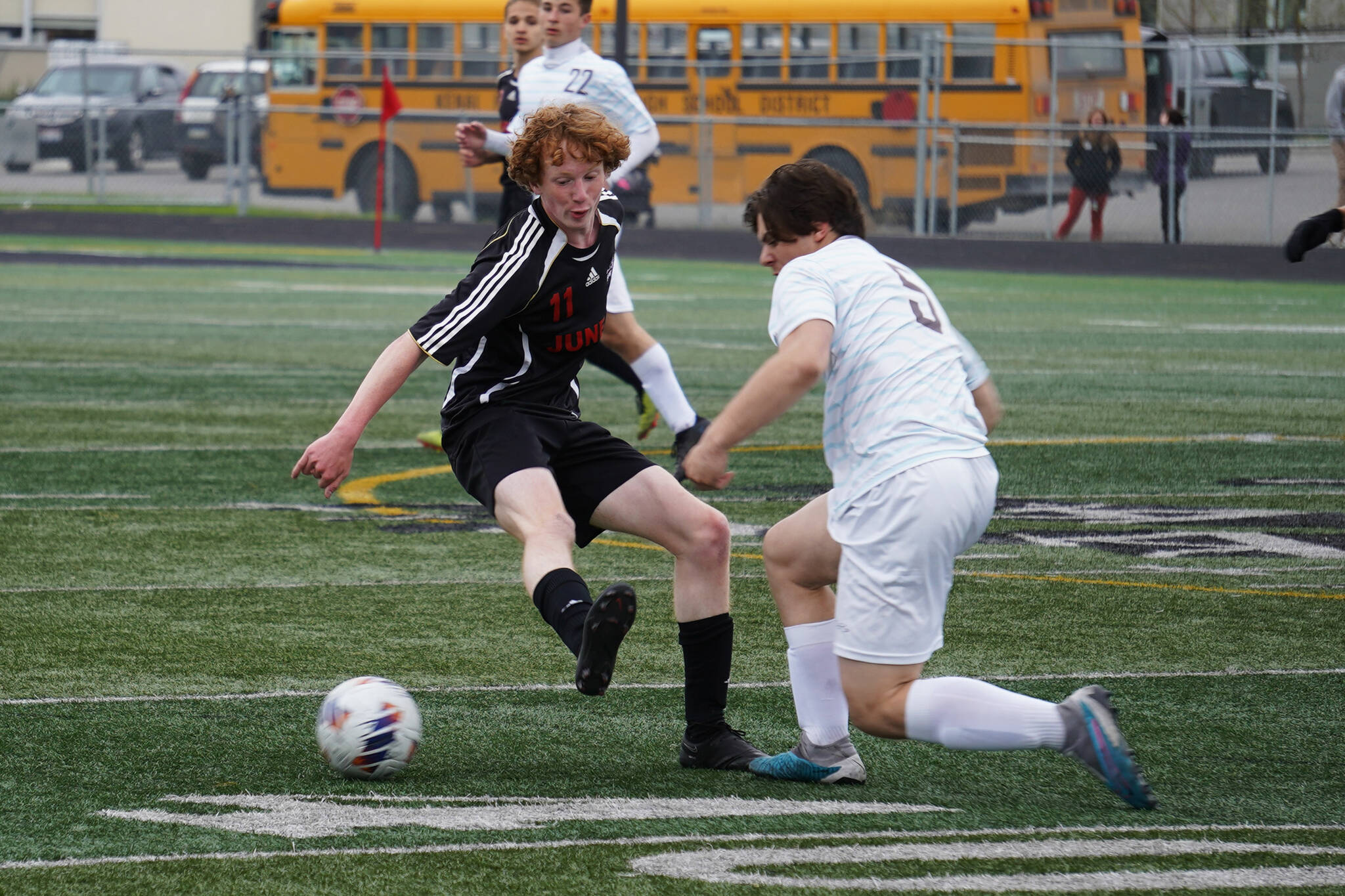 Juneau-Douglas’s Emmett Mesdag battles for the ball with Soldotna’s Gehret Medcoff during the Division II Soccer State Championship on Saturday, May 27, 2023, at West Anchorage High School in Anchorage, Alaska.