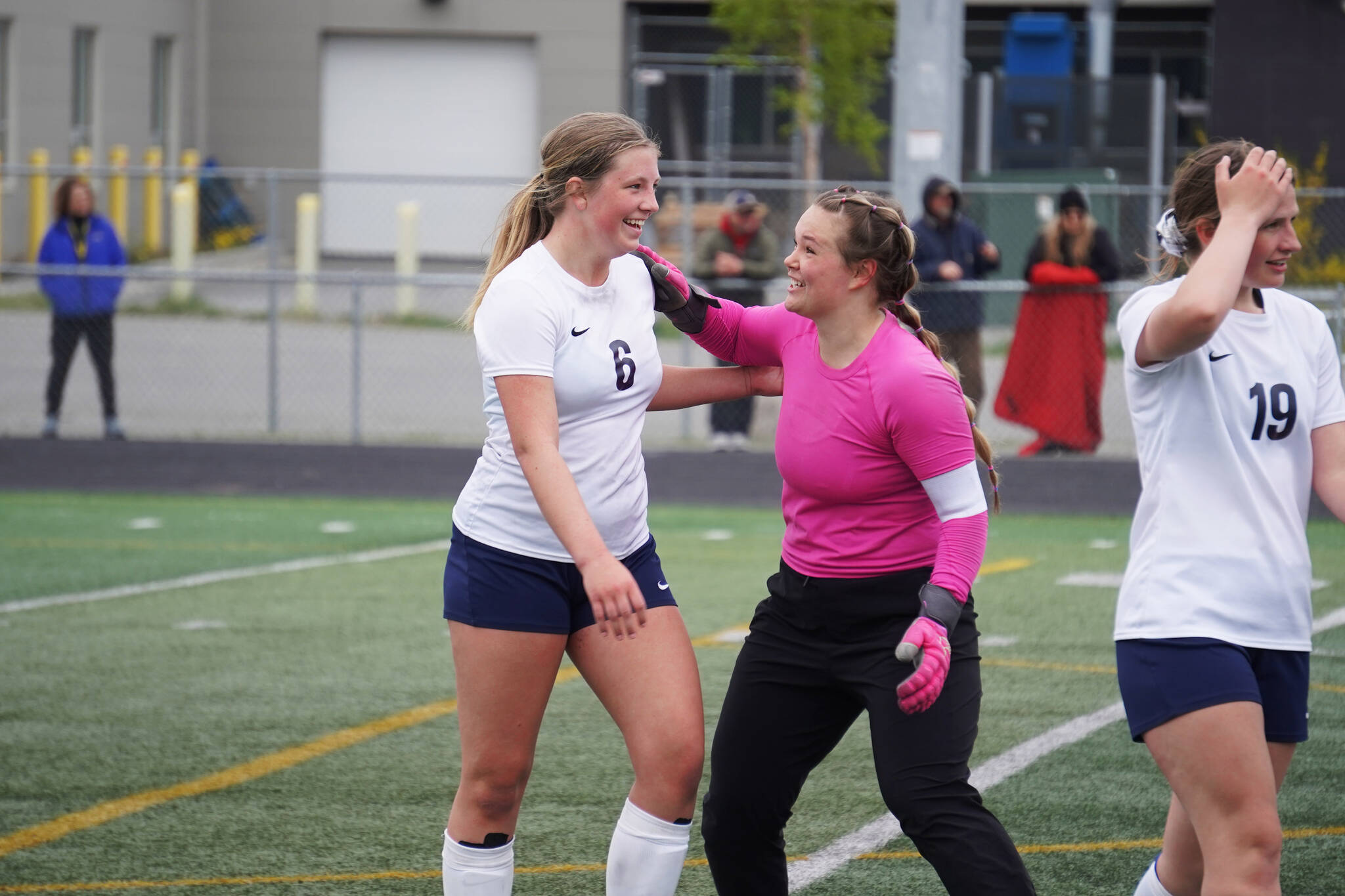 Soldotna’s Alexandra Lee and Sunny Miller celebrate after the end of the fourth half of overtime during the Division II Soccer State Championship on Saturday, May 27, 2023, at West Anchorage High School in Anchorage, Alaska. (Jake Dye/Peninsula Clarion)