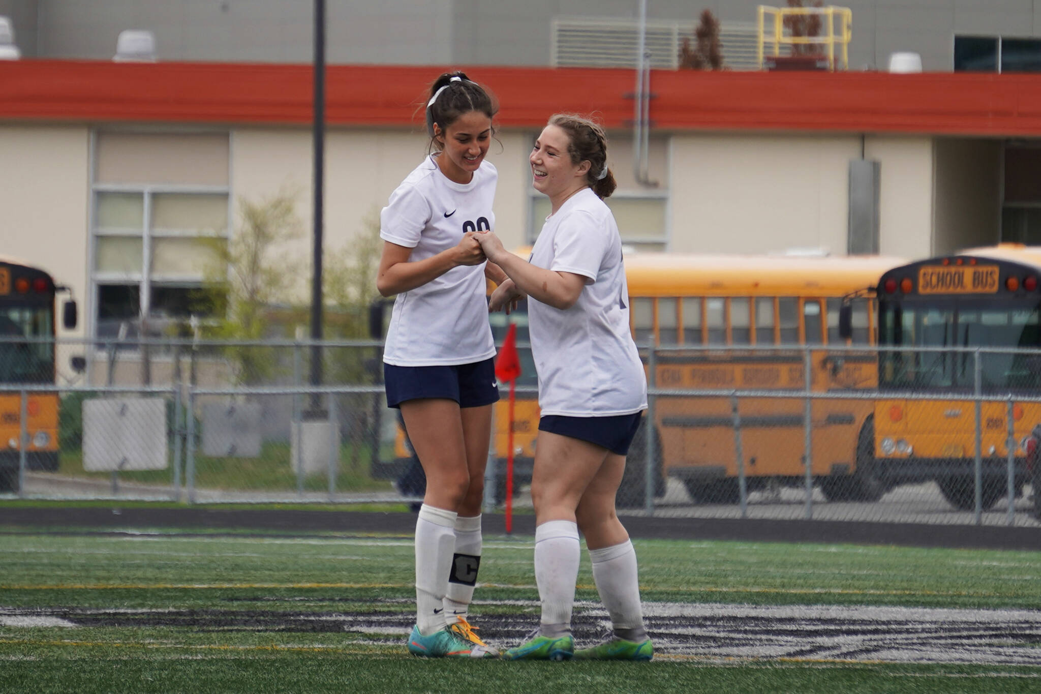 Soldotna’s Zayra Poage and Liberty Miller celebrate after Miller scored a goal during the Division II Soccer State Championship on Saturday, May 27, 2023, at West Anchorage High School in Anchorage, Alaska. (Jake Dye/Peninsula Clarion)