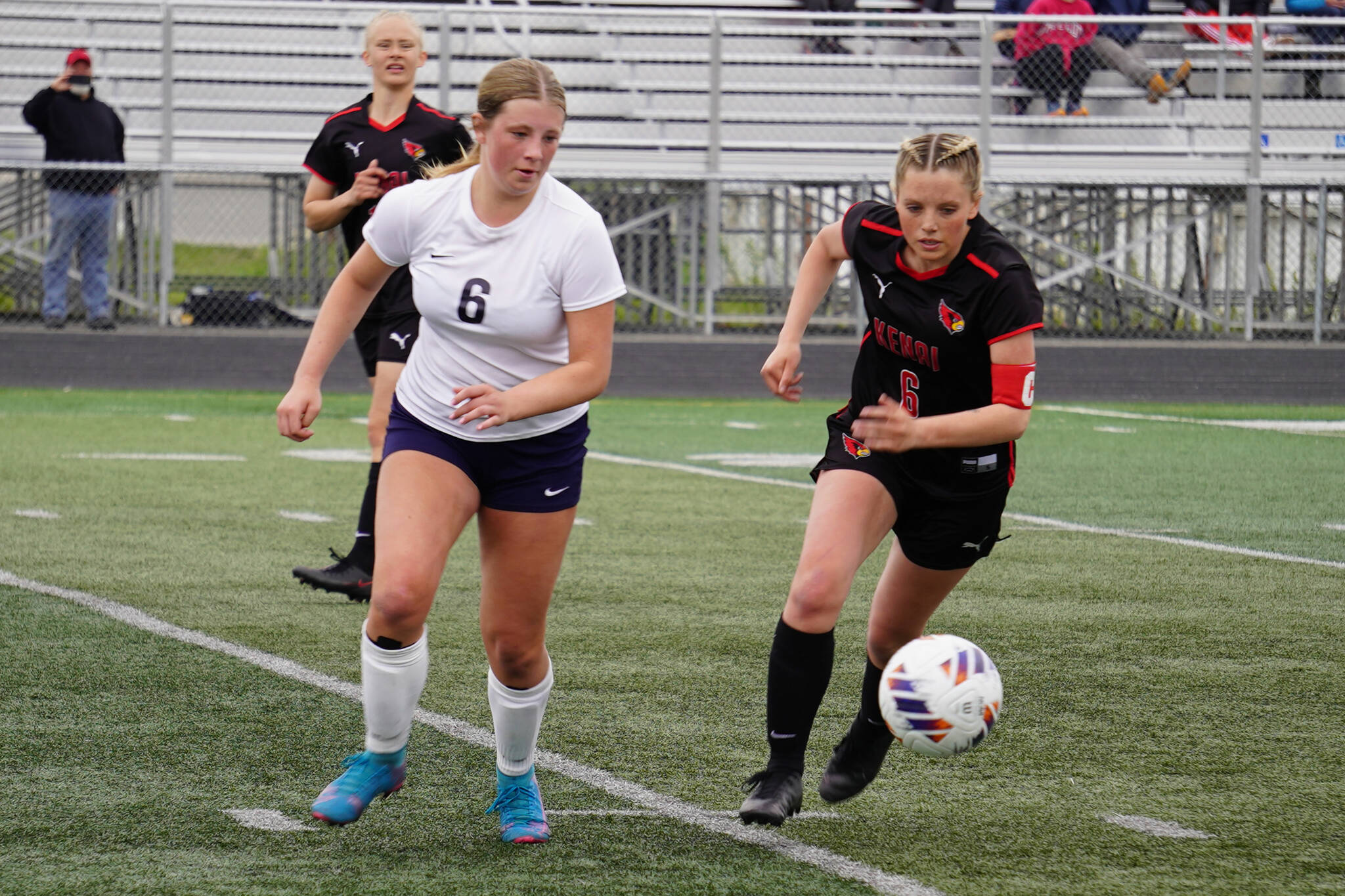 Soldotna’s Alexandra Lee and Kenai Central’s Kori Moore race after the ball during the Division II Soccer State Championship on Saturday, May 27, 2023, at West Anchorage High School in Anchorage, Alaska. (Jake Dye/Peninsula Clarion)