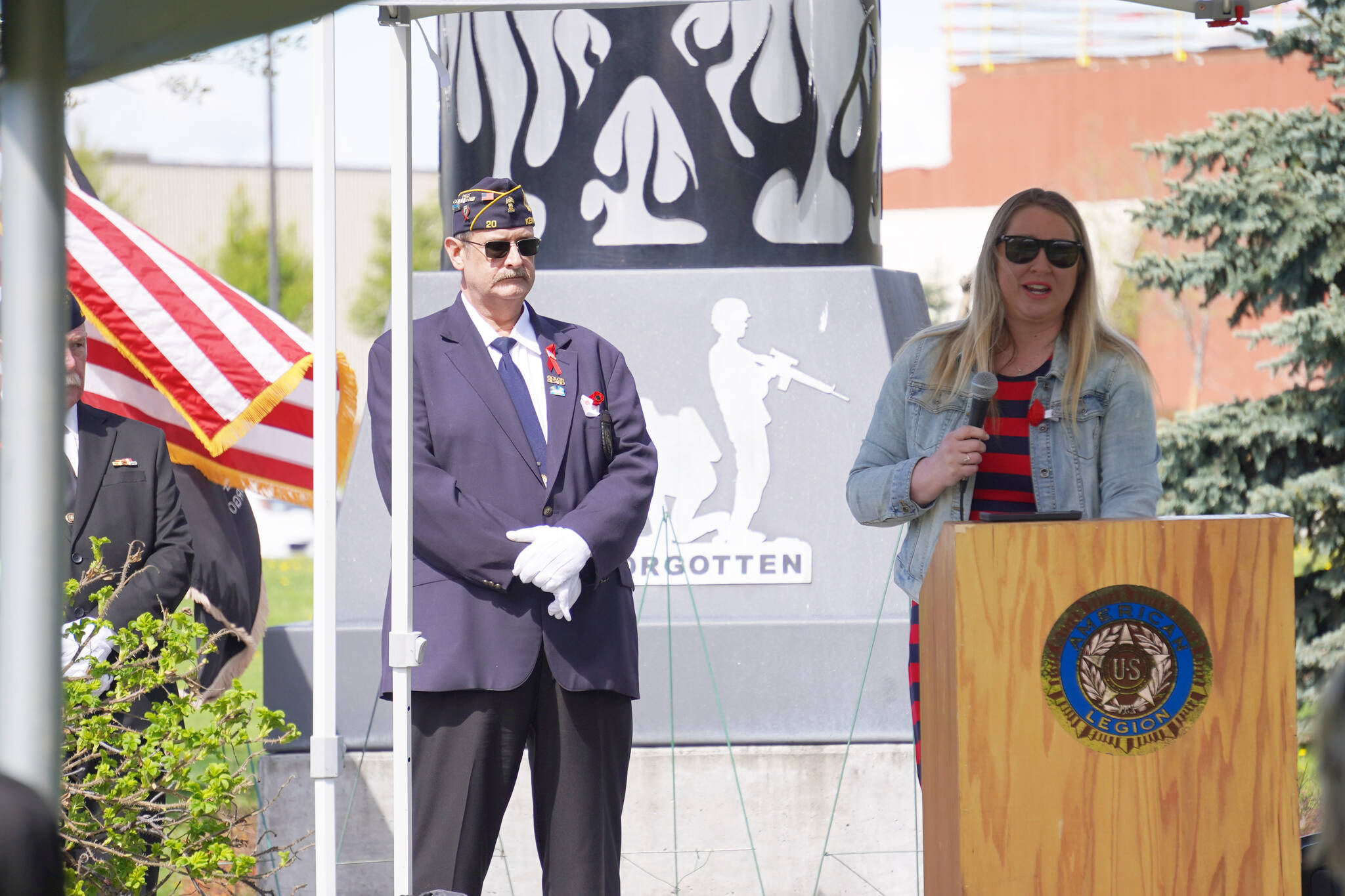 American Legion Post 20 Past Cmdr. David Segura stands as Jill Schaefer speaks on behalf of Gov. Mike Dunleavy during a Memorial Day ceremony on Monday, May 29, 2023, at Leif Hanson Memorial Park in Kenai, Alaska. (Jake Dye/Peninsula Clarion)