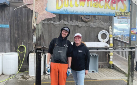 Emilie Springer/ Homer News
George Gustufson and Ayjan Arik, owners of Buttwhackers Fillet Company, stand in front of their business, at the top of Ramp 1 behind the Salty Dawg at the Homer Harbor on Monday. The business is the 2023 tournament headquarters and weigh-in station.