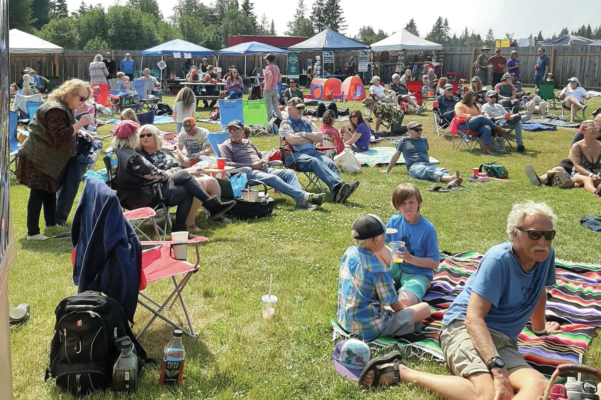 Photo provided by Josh Krohn, KBBI 
Community members take in the 2022 Concert on the Lawn held at the Down East Saloon.