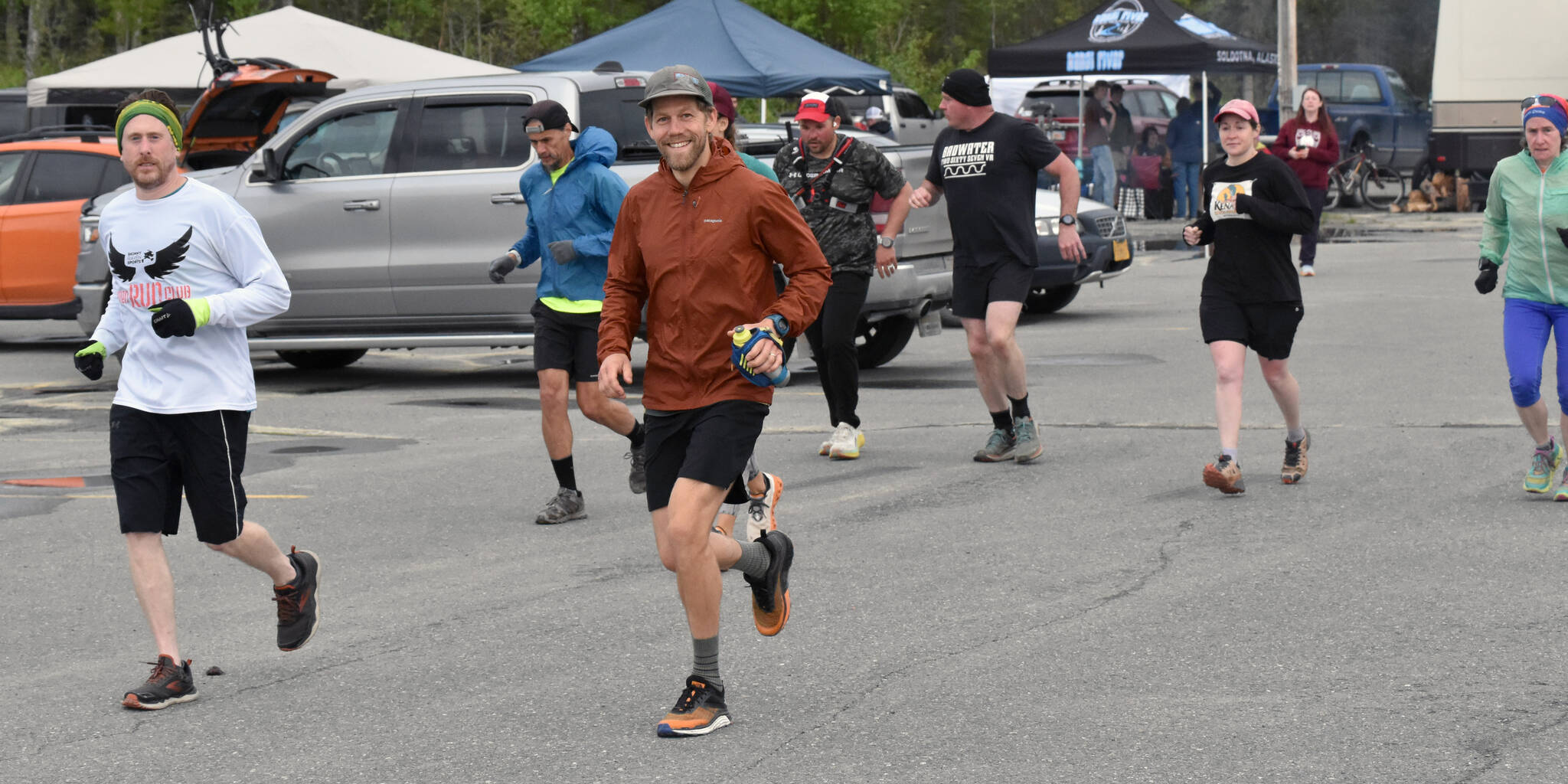 Anchorage’s David Short and Girdwood’s Zach Behney lead runners on the fifth lap, or “yard,” at the Tsalteshi Backyard Ultra on Friday, June 9, 2023, at the parking lot of the Soldotna Regional Sports Complex in Soldotna, Alaska. (Photo by Jeff Helminiak/Peninsula Clarion)