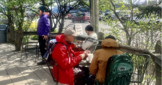 Visitors enjoy coffee and treats along a boardwalk on the Homer Spit on Wednesday, June 14, 2023 in Homer, Alaska. Photo by Christina Whiting