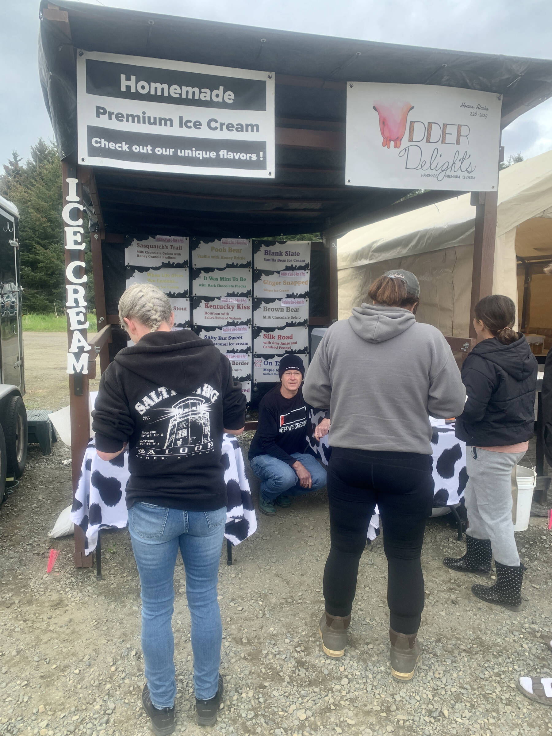 Udder Delights owner Todd Hindman helps customers at his booth at the Homer Farmers Market on Wednesday, May 31, 2023 in Homer, Alaska. Photo by Christina Whiting