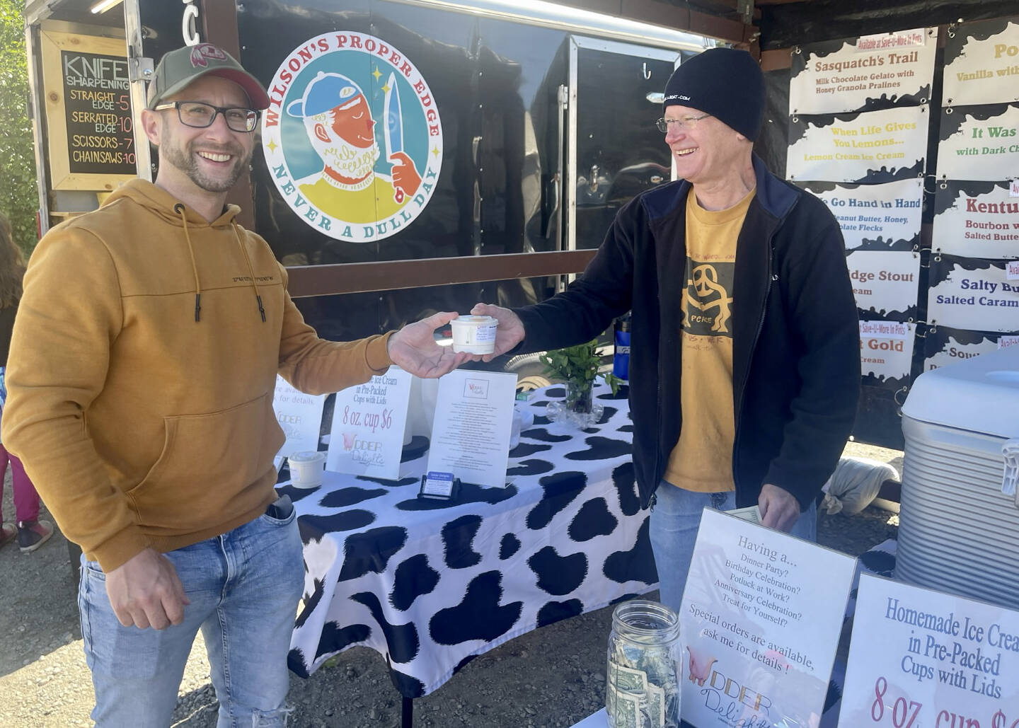 Armin Holzner from Austria purchases ice cream from Todd Hindman’s Udder Delights booth at the Homer Farmers Market on Saturday, June 17, 2023 in Homer, Alaska. Photo by Christina Whiting