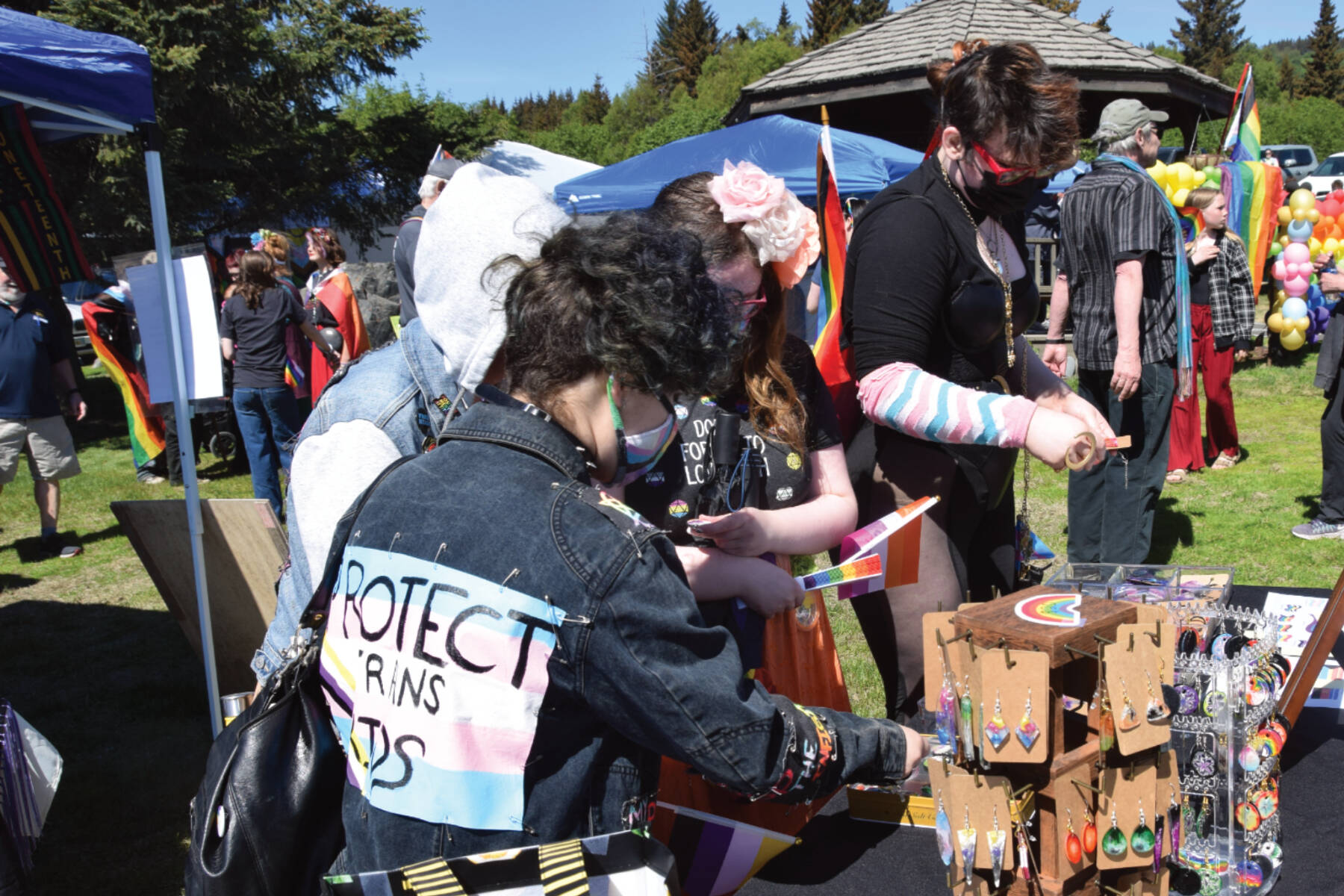 Attendees of the Homer Pride and Juneteenth Liberation Celebration browse for handcrafted merch by Kachemak Bay Crafters at WKFL Park on Saturday, June 17, 2023 in Homer, Alaska. (Delcenia Cosman/Homer News)