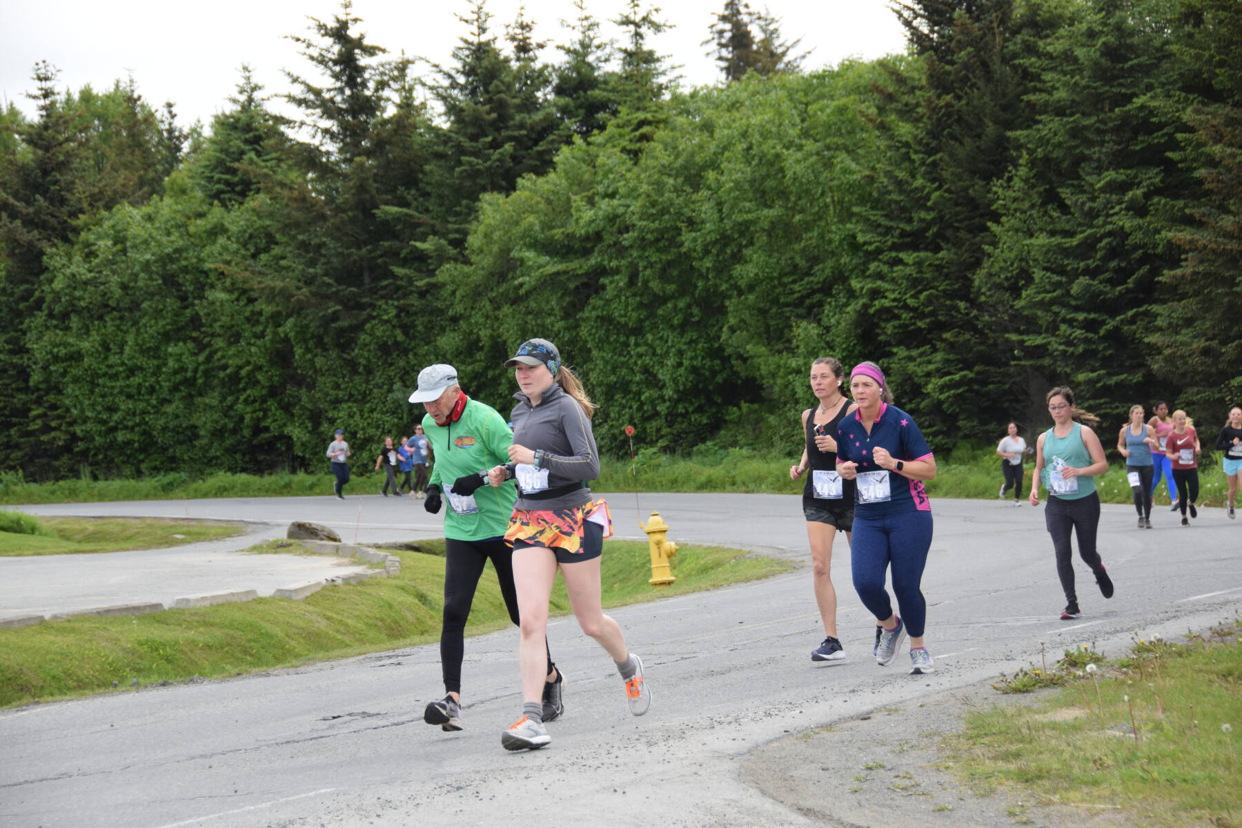 Runners participating in the Homer Spit Run 10K to the Bay race round the curve of Ben Walters Lane on Saturday, June 24, 2023 in Homer, Alaska. (Delcenia Cosman/Homer News)