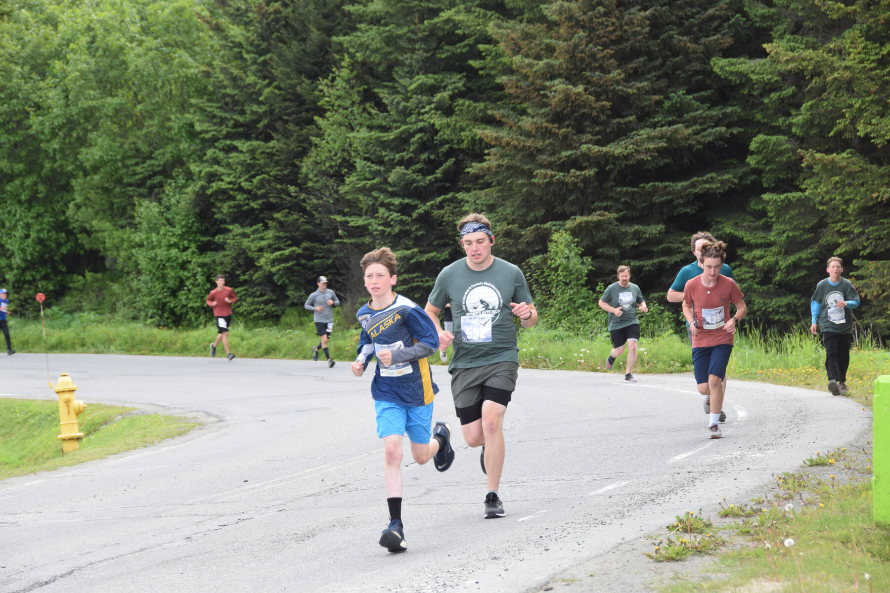 Runners participating in the Homer Spit Run 10K to the Bay race round the curve of Ben Walters Lane on Saturday, June 24, 2023 in Homer, Alaska. (Delcenia Cosman/Homer News)