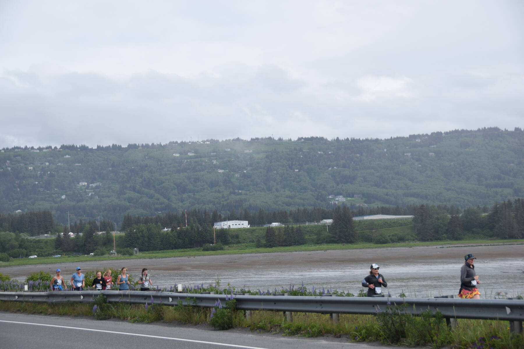 Participants in the Homer Spit Run 10K to the Bay race run down the Spit Road toward the finish line at Land’s End on Saturday, June 24, 2023 in Homer, Alaska. (Delcenia Cosman/Homer News)