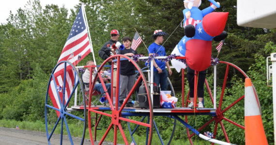 Community members ride on the Anchor Point VFW Post 10221 float down School Street during the Anchor Point Fourth of July parade on Tuesday, July 4, 2023 in Anchor Point, Alaska. (Delcenia Cosman/Homer News)